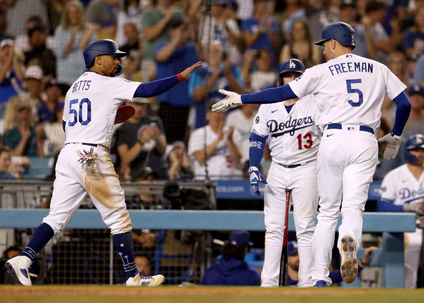 LOS ANGELES, CALIFORNIA - AUGUST 06: Mookie Betts #50 of the Los Angeles Dodgers celebrates his run from a Freddie Freeman #5 sacrifice fly, for a 6-3 lead over the San Diego Padres, during the seventh inning at Dodger Stadium on August 06, 2022 in Los Angeles, California. (Photo by Harry How/Getty Images)
