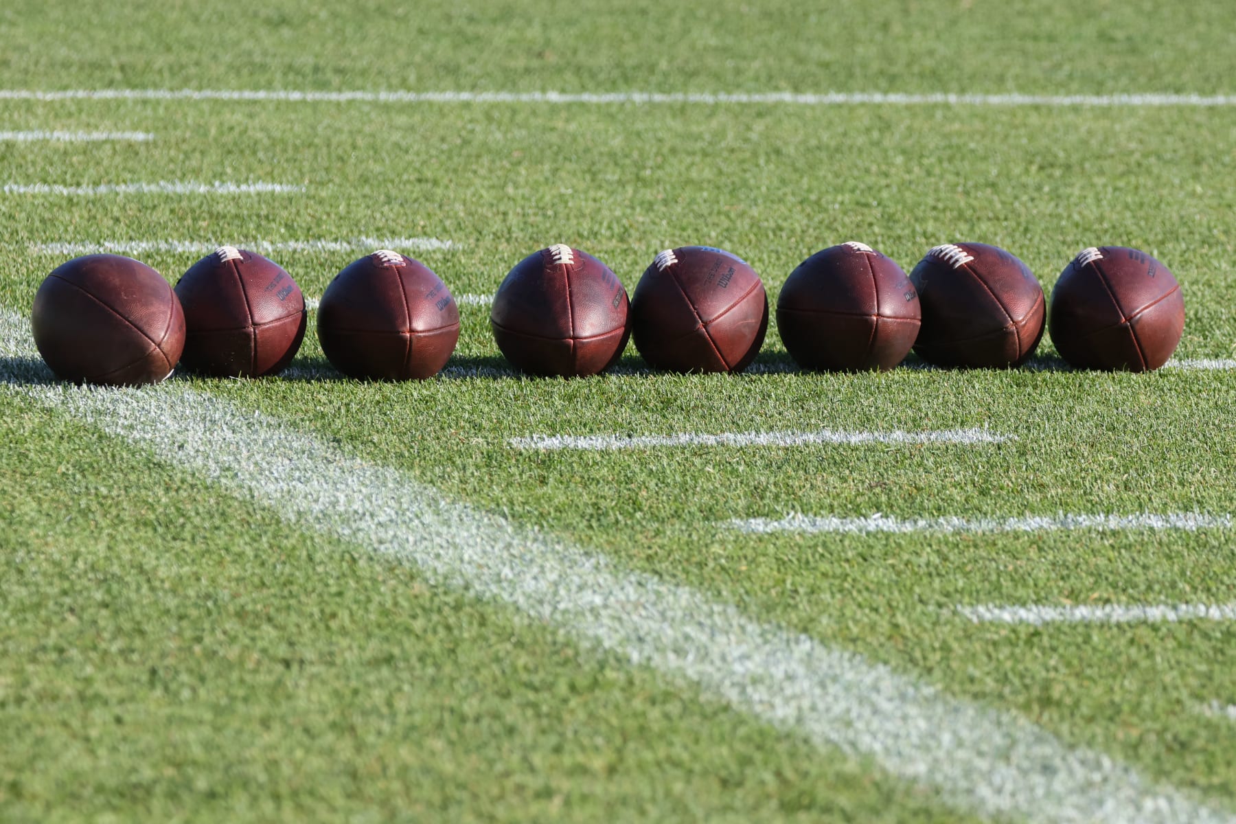 ALLEN PARK, MI - AUGUST 10:  A general view of practice footballs lined up on the field is seen during the Detroit Lions Training Camp practice on August 10, 2022 at the Detroit Lions Training Facility in Allen Park, Michigan.  (Photo by Scott W. Grau/Icon Sportswire via Getty Images)