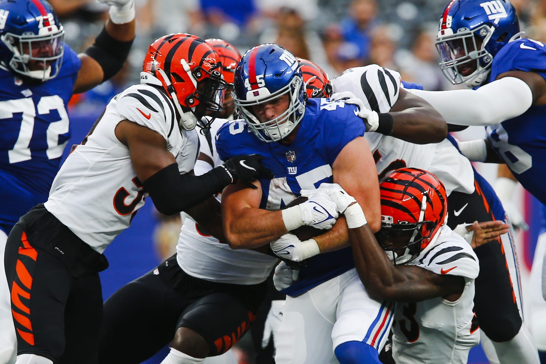 New York Giants' Daniel Bellinger (45) is tackled by Cincinnati Bengals' Akeem Davis-Gaither, left, during the first half of a preseason NFL football game Sunday, Aug. 21, 2022, in East Rutherford, N.J. (AP Photo/John Munson)
