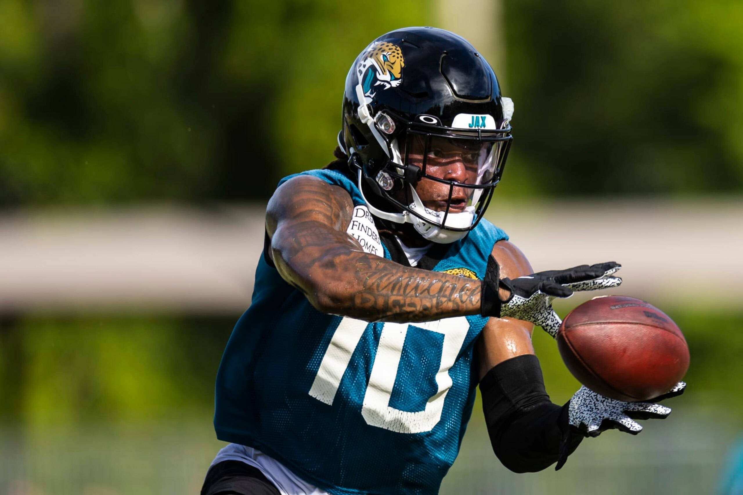 JACKSONVILLE, FLORIDA - JULY 26: Laviska Shenault Jr. #10 of the Jacksonville Jaguars catches a pass during Training camp on July 26, 2022 at Episcopal High School in Jacksonville, Florida. (Photo by James Gilbert/Getty Images)