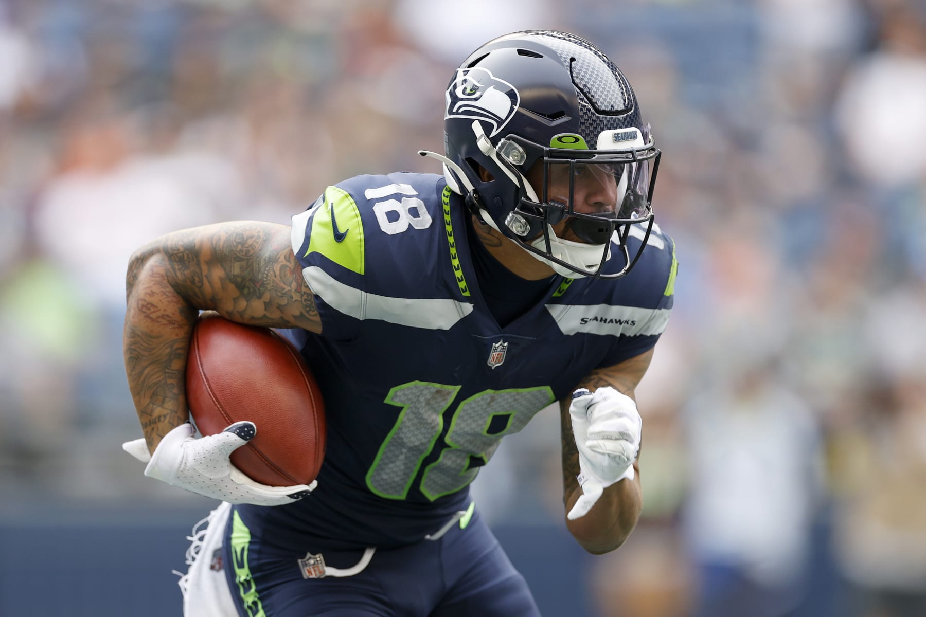 SEATTLE, WASHINGTON - AUGUST 18: Freddie Swain #18 of the Seattle Seahawks carries the ball in the first half during the preseason game between the Seattle Seahawks and the Chicago Bears at Lumen Field on August 18, 2022 in Seattle, Washington. (Photo by Steph Chambers/Getty Images)