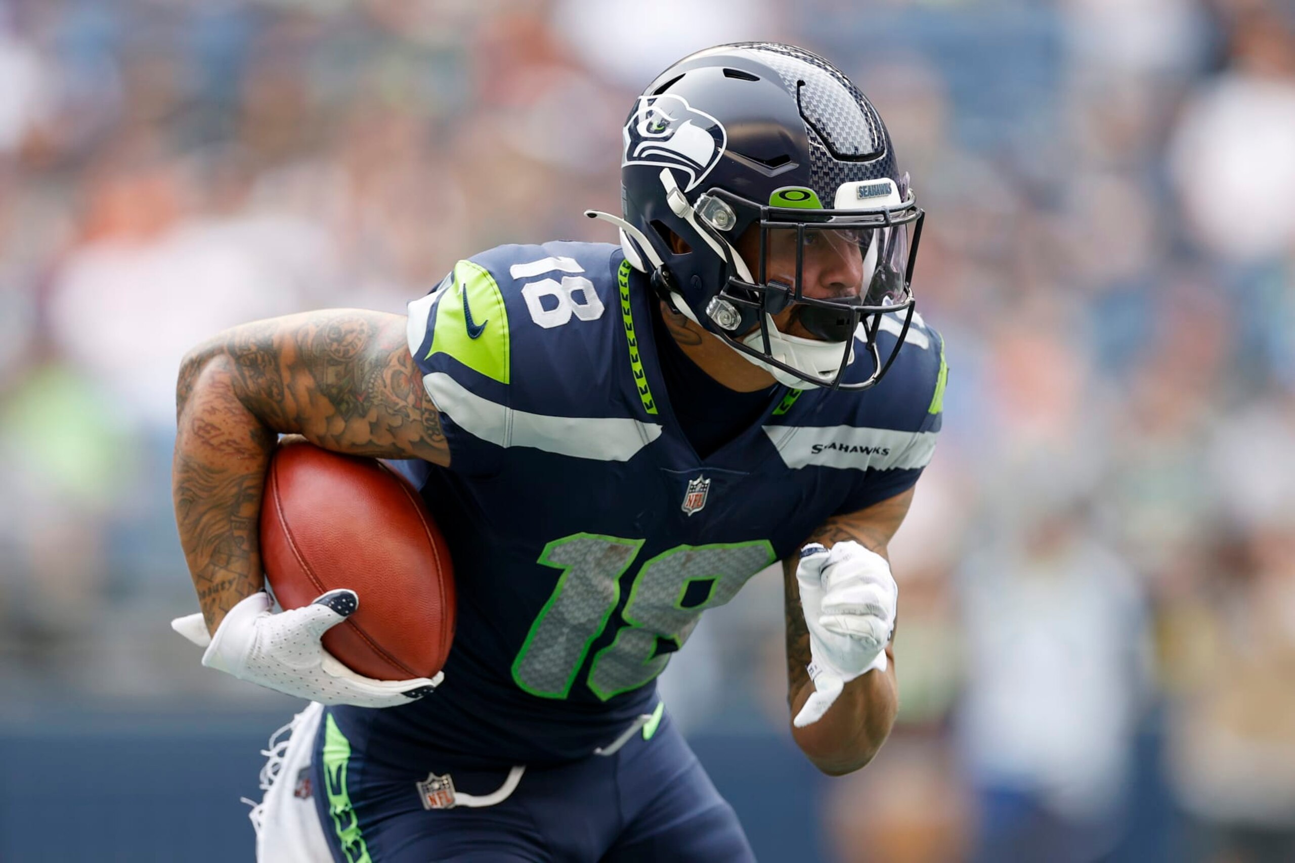SEATTLE, WASHINGTON - AUGUST 18: Freddie Swain #18 of the Seattle Seahawks carries the ball in the first half during the preseason game between the Seattle Seahawks and the Chicago Bears at Lumen Field on August 18, 2022 in Seattle, Washington. (Photo by Steph Chambers/Getty Images)