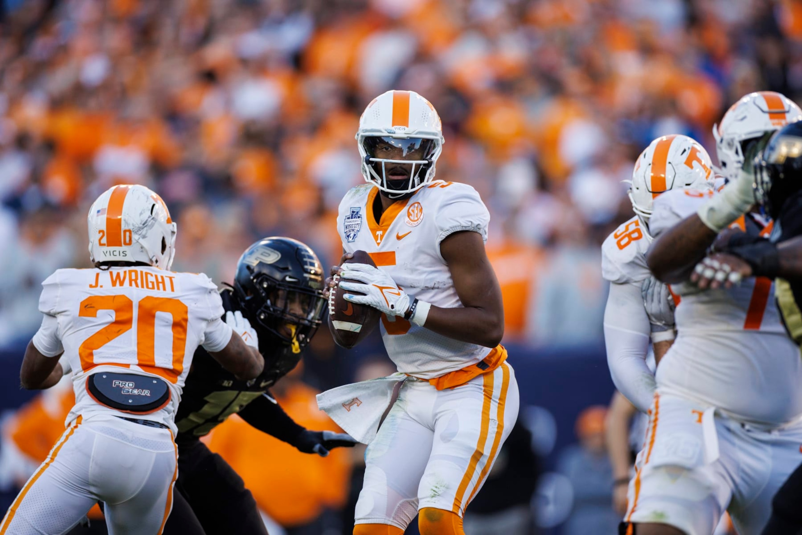 NASHVILLE, TN - DECEMBER 30:  Hendon Hooker #5 of the Tennessee Volunteers moves in the pocket against the Purdue Boilermakers during the first half of the TransPerfect Music City Bowl at Nissan Stadium on December 30, 2021 in Nashville, Tennessee. Purdue defeats Tennessee 48-45 in overtime. (Photo by Brett Carlsen/Getty Images)