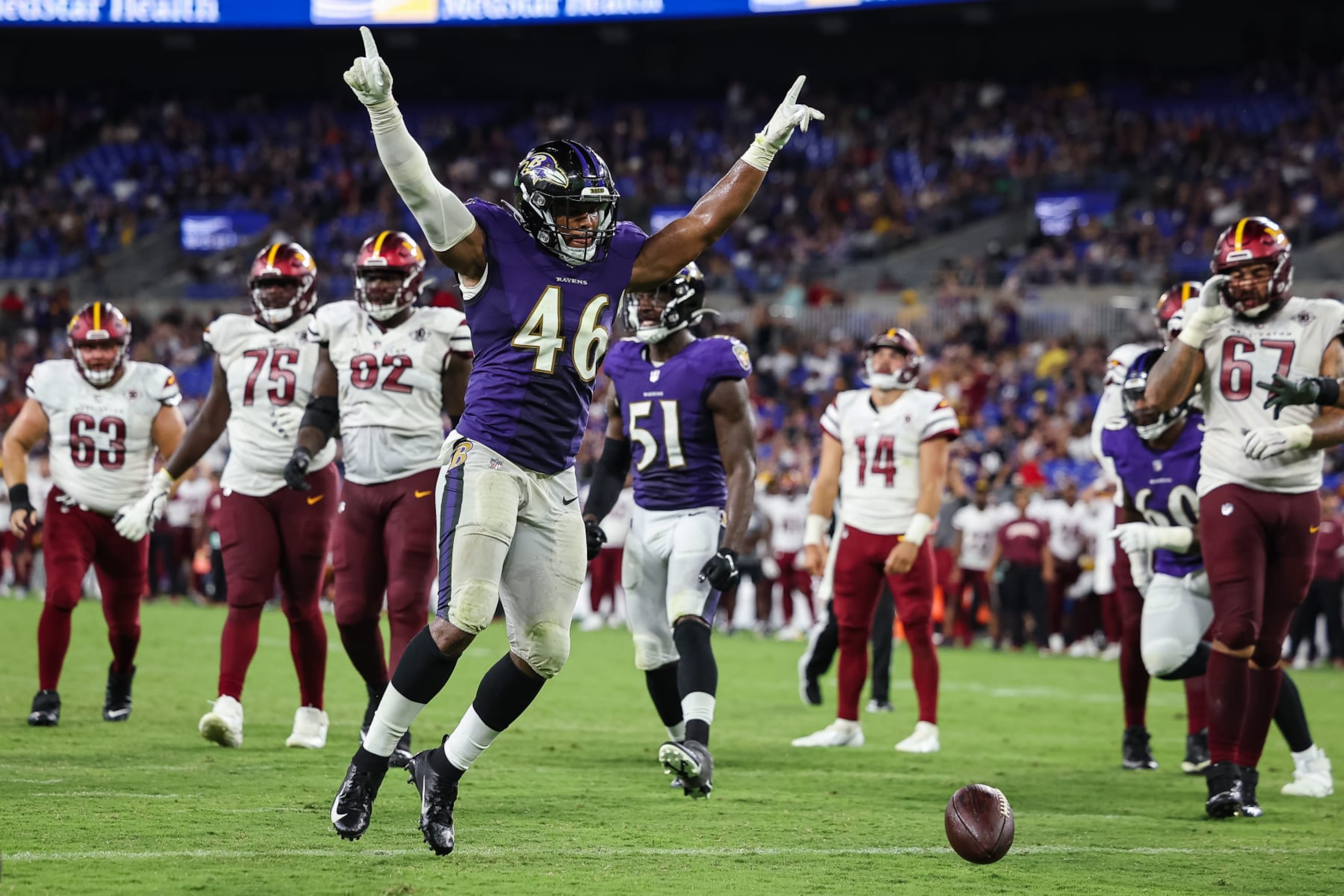 BALTIMORE, MD - AUGUST 27: Josh Ross #46 of the Baltimore Ravens celebrates after a Washington Commanders two point conversion attempt is denied during the second half of a preseason game at M&T Bank Stadium on August 27, 2022 in Baltimore, Maryland. (Photo by Scott Taetsch/Getty Images)