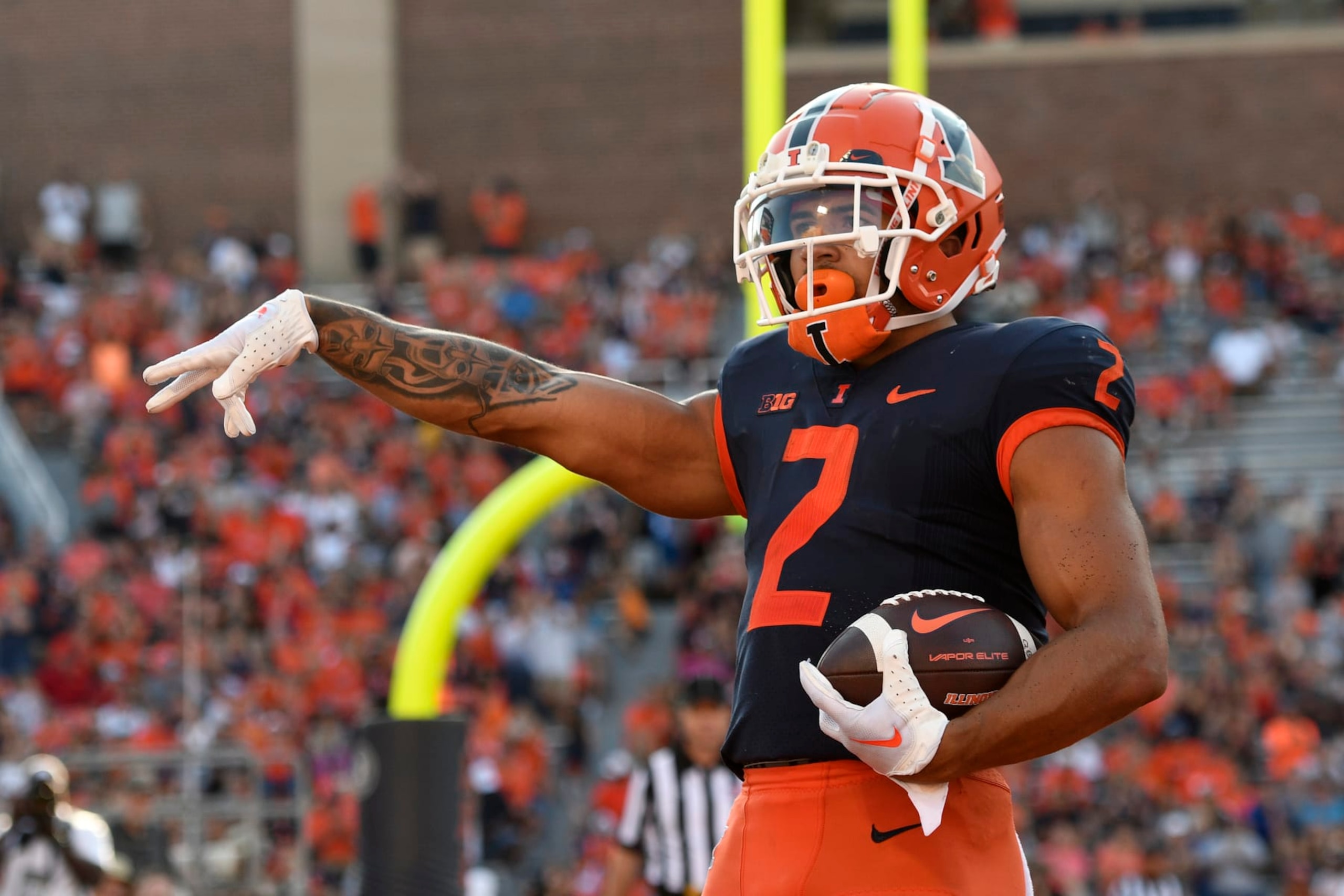 CHAMPAIGN, IL - AUGUST 27: Illinois Fighting Illini running back Chase Brown (2) celebrates after scoring a touchdown during the college football game between the Wyoming Cowboys and the Illinois Fighting Illini on August 27, 2022, at Memorial Stadium in Champaign, Illinois. (Photo by Michael Allio/Icon Sportswire via Getty Images) CHAMPAIGN, IL - AUGUST 27: Illinois Fighting Illini running back Chase Brown (2) celebrates after scoring a touchdown during the college football game between the Wyoming Cowboys and the Illinois Fighting Illini on August 27, 2022, at Memorial Stadium in Champaign, Illinois. (Photo by Michael Allio/Icon Sportswire via Getty Images)