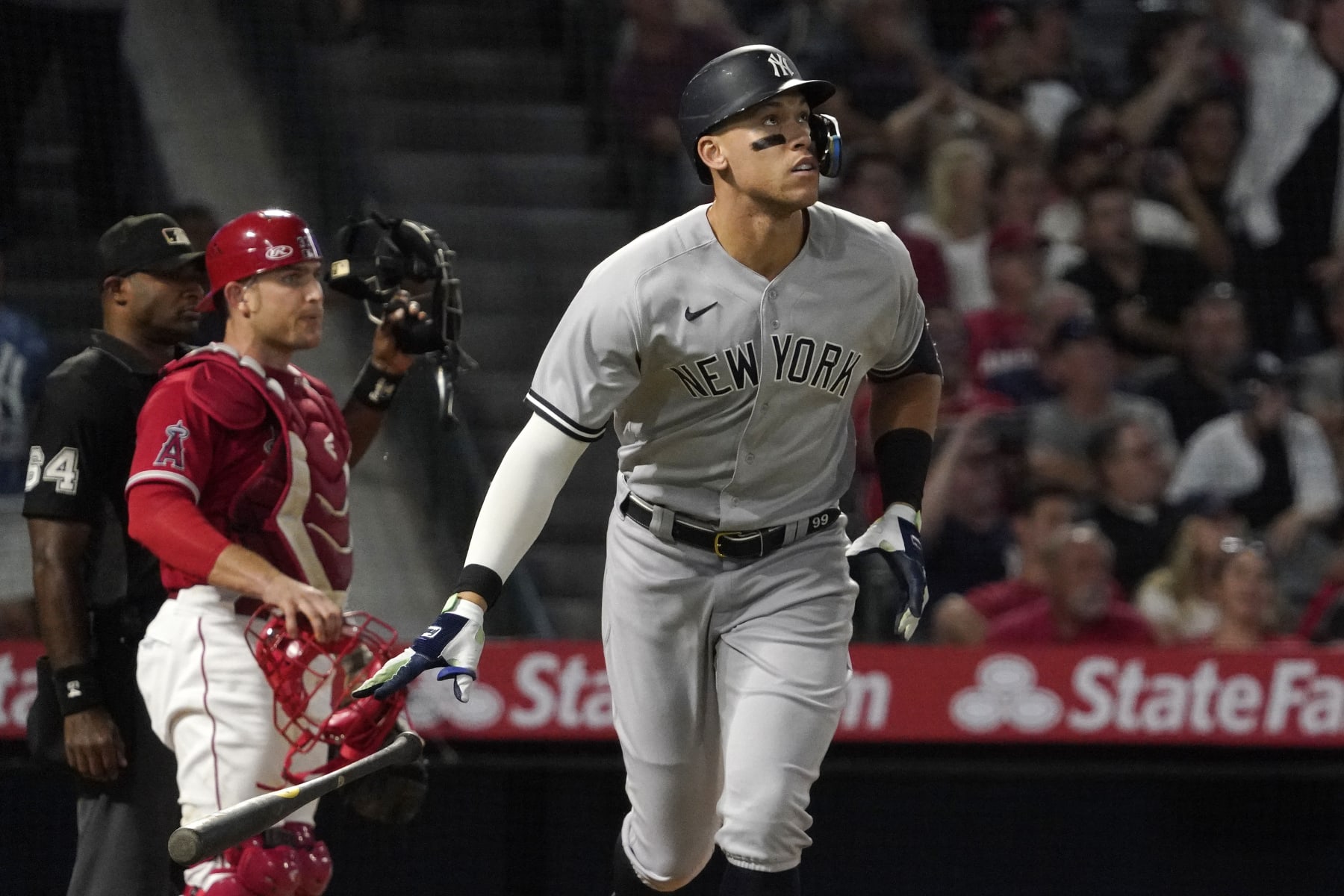 New York Yankees' Aaron Judge, right, drops his bat after hitting a three-run home run as Los Angeles Angels catcher Max Stassi, center, watches along with home plate umpire Alan Porter during the XX inning of a baseball game Tuesday, Aug. 30, 2022, in Anaheim, Calif. (AP Photo/Mark J. Terrill)