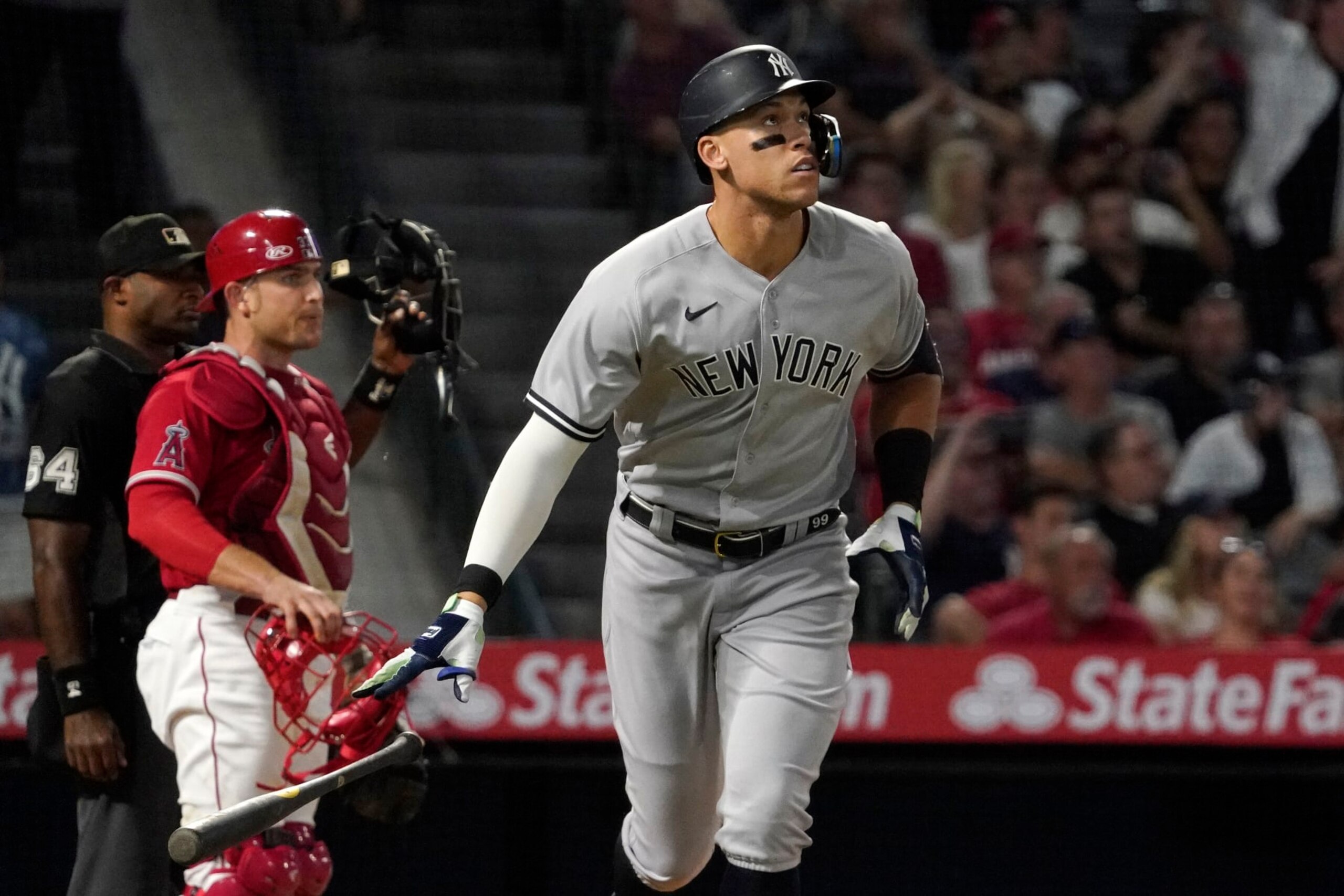 New York Yankees' Aaron Judge, right, drops his bat after hitting a three-run home run as Los Angeles Angels catcher Max Stassi, center, watches along with home plate umpire Alan Porter during the XX inning of a baseball game Tuesday, Aug. 30, 2022, in Anaheim, Calif. (AP Photo/Mark J. Terrill)