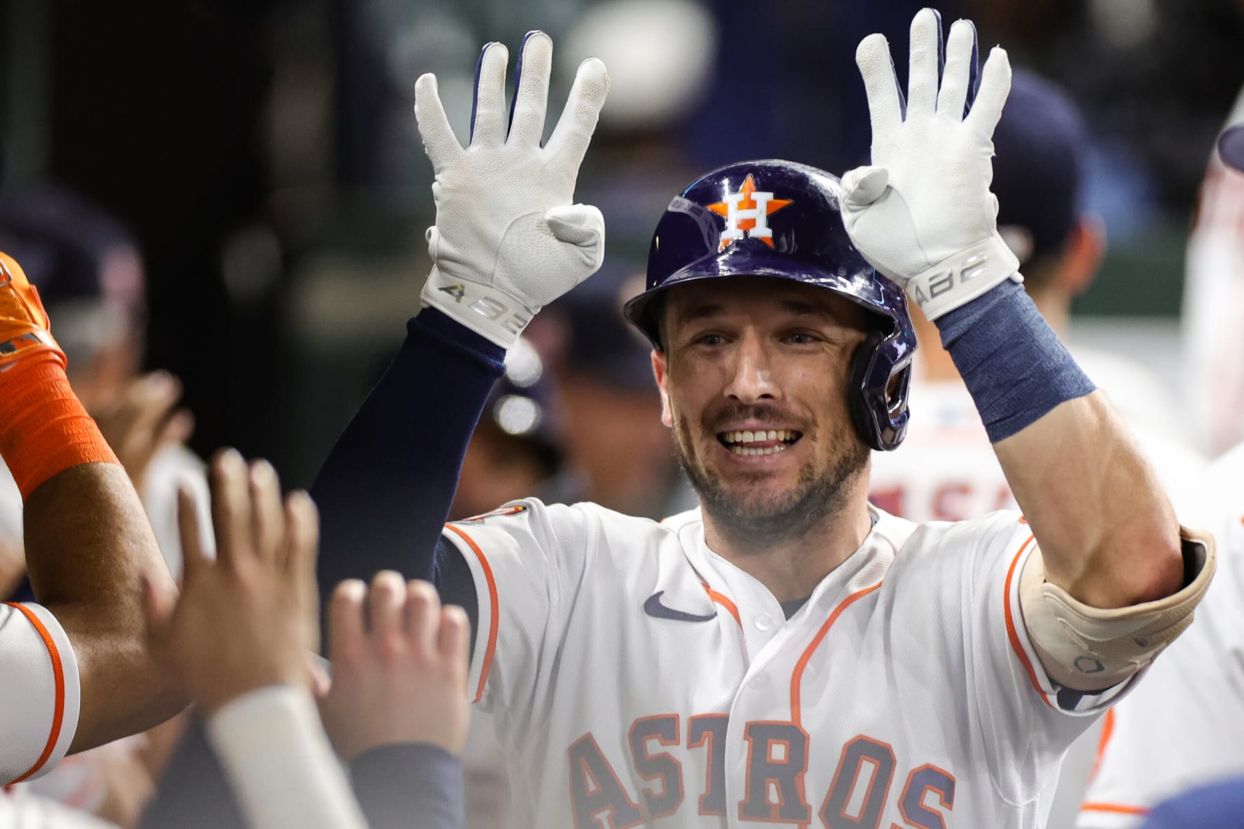 HOUSTON, TEXAS - AUGUST 23: Alex Bregman #2 of the Houston Astros high fives teammates after hitting a two run home run during the seventh inning against the Minnesota Twins at Minute Maid Park on August 23, 2022 in Houston, Texas. (Photo by Carmen Mandato/Getty Images)