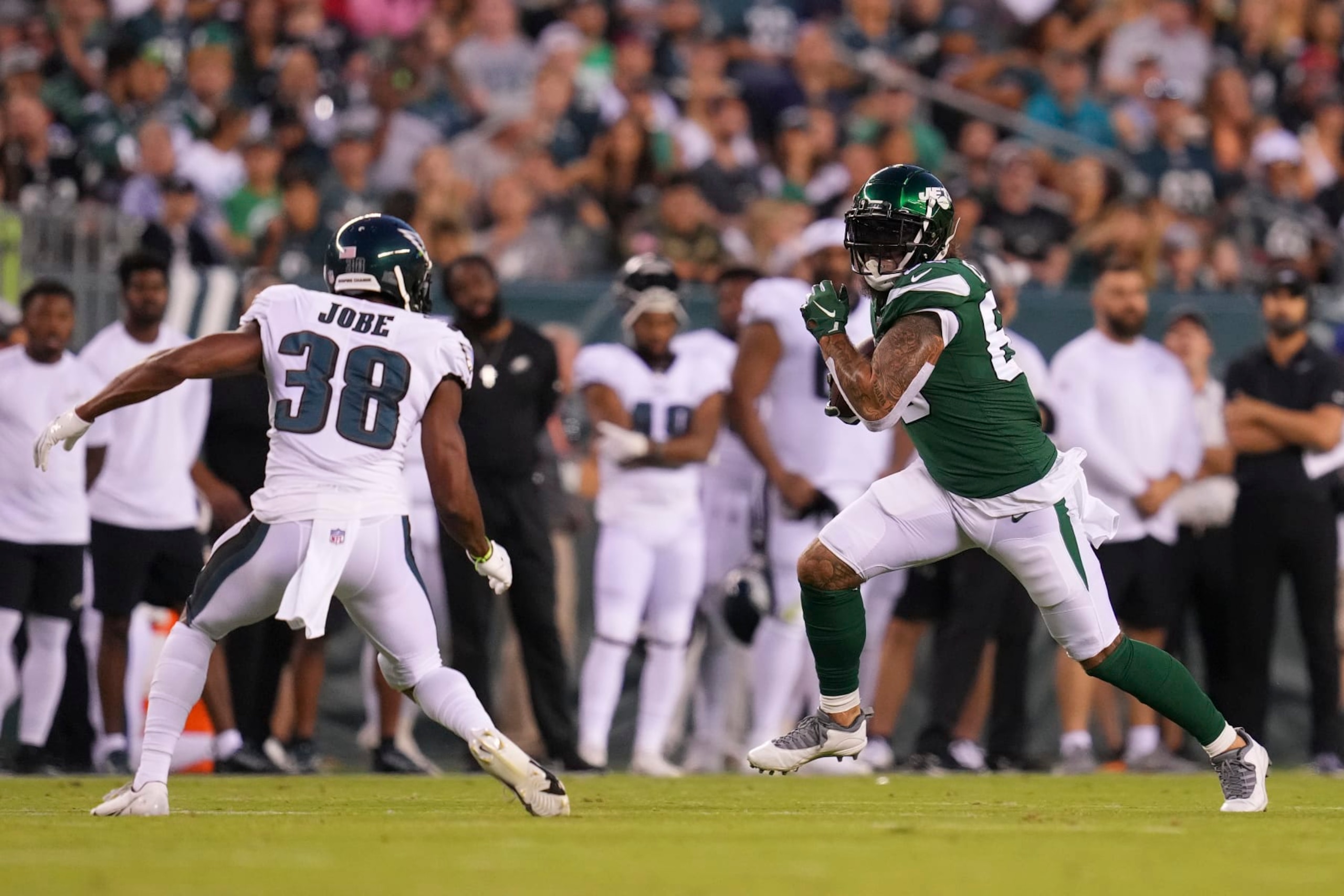 PHILADELPHIA, PA - AUGUST 12: Tyler Conklin #83 of the New York Jets runs with the ball against Josh Jobe #38 of the Philadelphia Eagles during the preseason game at Lincoln Financial Field on August 12, 2022 in Philadelphia, Pennsylvania. The Jets defeated the Eagles 24-21. (Photo by Mitchell Leff/Getty Images)
