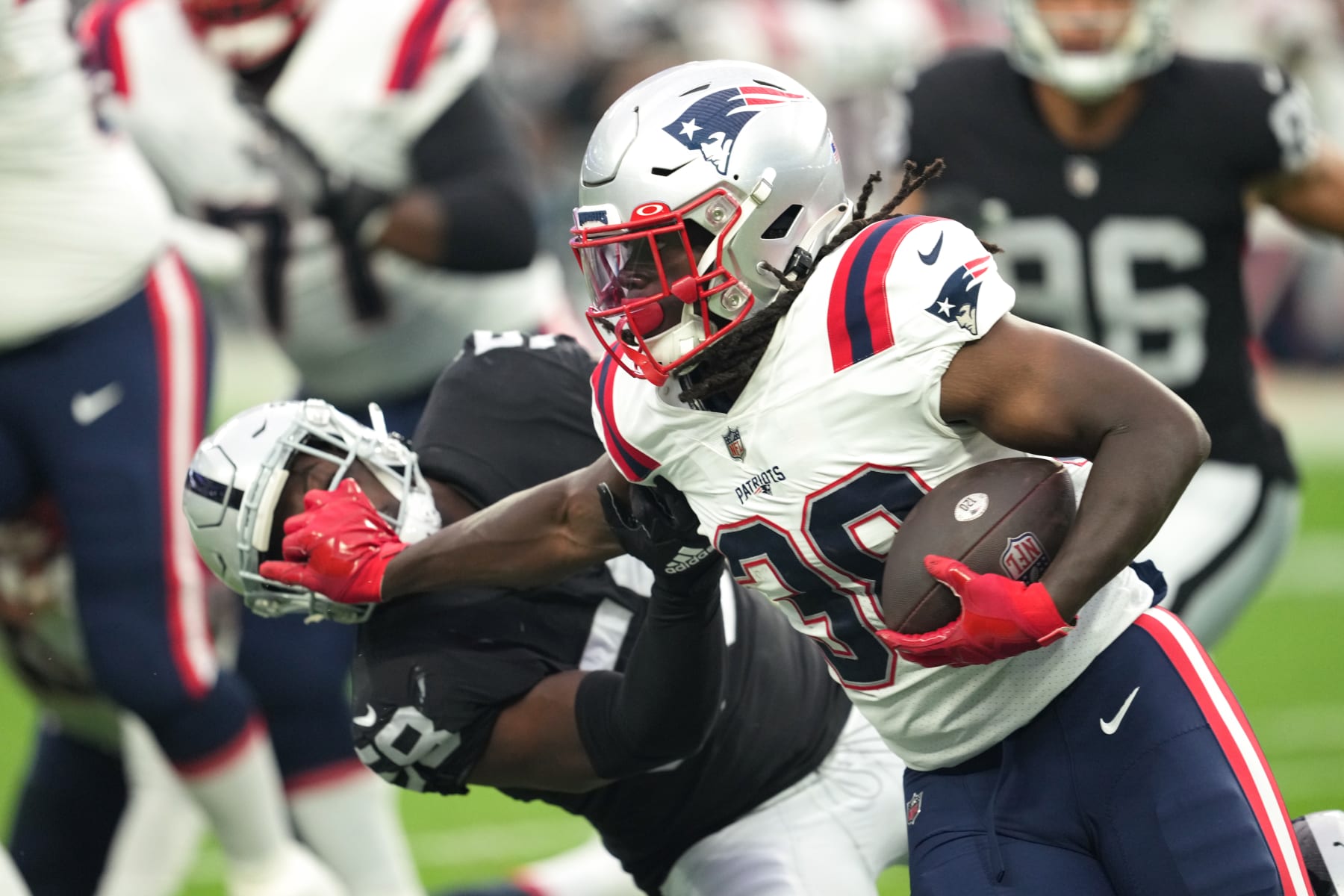 LAS VEGAS, NEVADA - AUGUST 26:  Running back Rhamondre Stevenson #38 of the New England Patriots runs with the ball against the Las Vegas Raiders defense during the first half of a preseason game at Allegiant Stadium on August 26, 2022 in Las Vegas, Nevada. (Photo by Chris Unger/Getty Images)