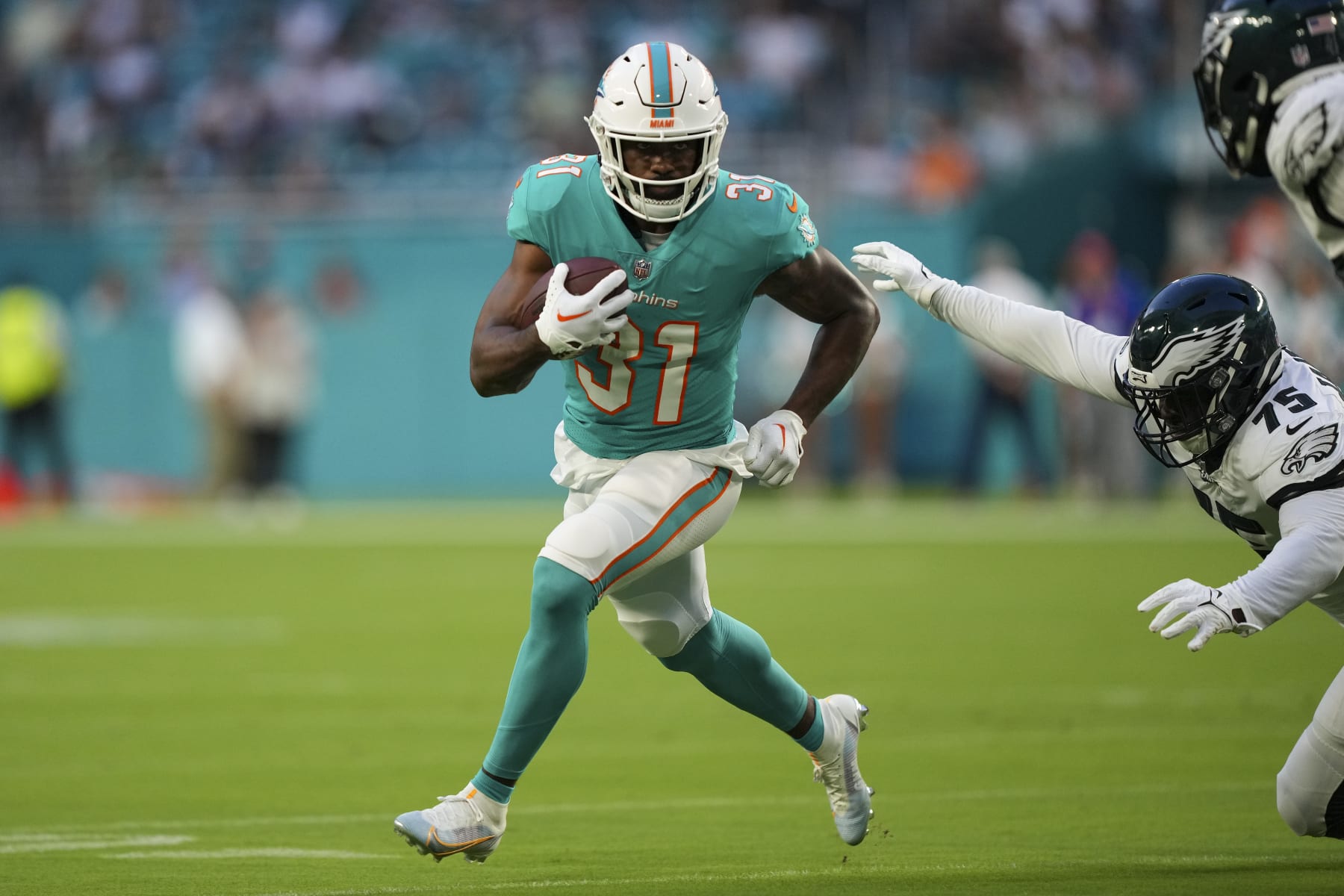 MIAMI GARDENS, FLORIDA - AUGUST 27: Raheem Mostert #31 of the Miami Dolphins rushes the football during the first quarter of the preseason game against the Philadelphia Eagles at Hard Rock Stadium on August 27, 2022 in Miami Gardens, Florida. (Photo by Eric Espada/Getty Images)