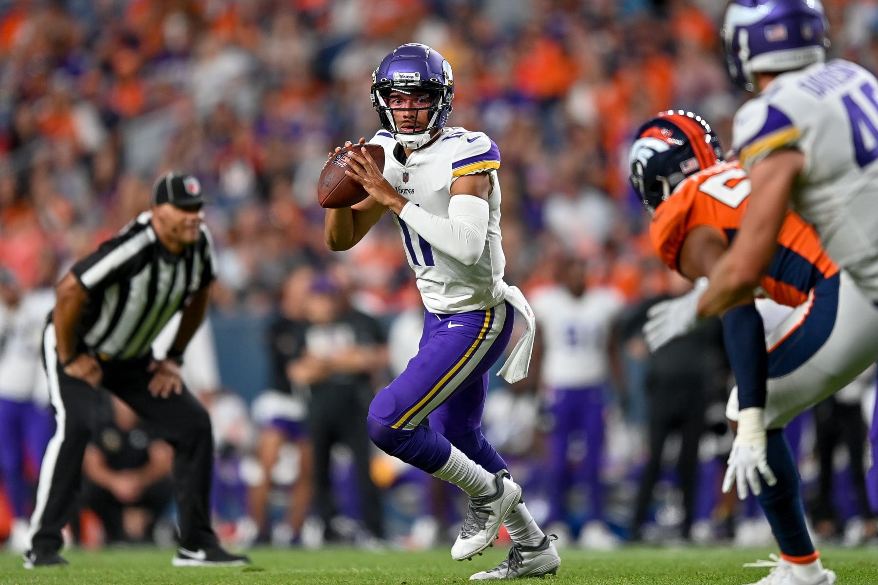 DENVER, COLORADO - AUGUST 27:  Quarterback Kellen Mond #11 of the Minnesota Vikings looks to pass against the Denver Broncos in the second half of a preason NFL game at Empower Field at Mile High on August 27, 2022 in Denver, Colorado. (Photo by Dustin Bradford/Getty Images)