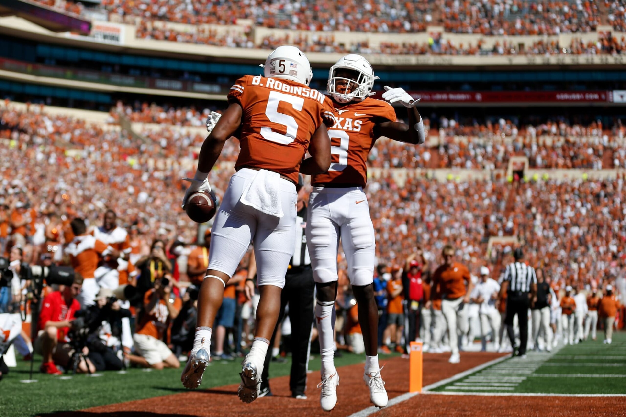 AUSTIN, TEXAS - SEPTEMBER 25: Xavier Worthy #8 of the Texas Longhorns congratulates Bijan Robinson #5 after a touchdown in the first quarter against the Texas Tech Red Raiders at Darrell K Royal-Texas Memorial Stadium on September 25, 2021 in Austin, Texas. (Photo by Tim Warner/Getty Images)