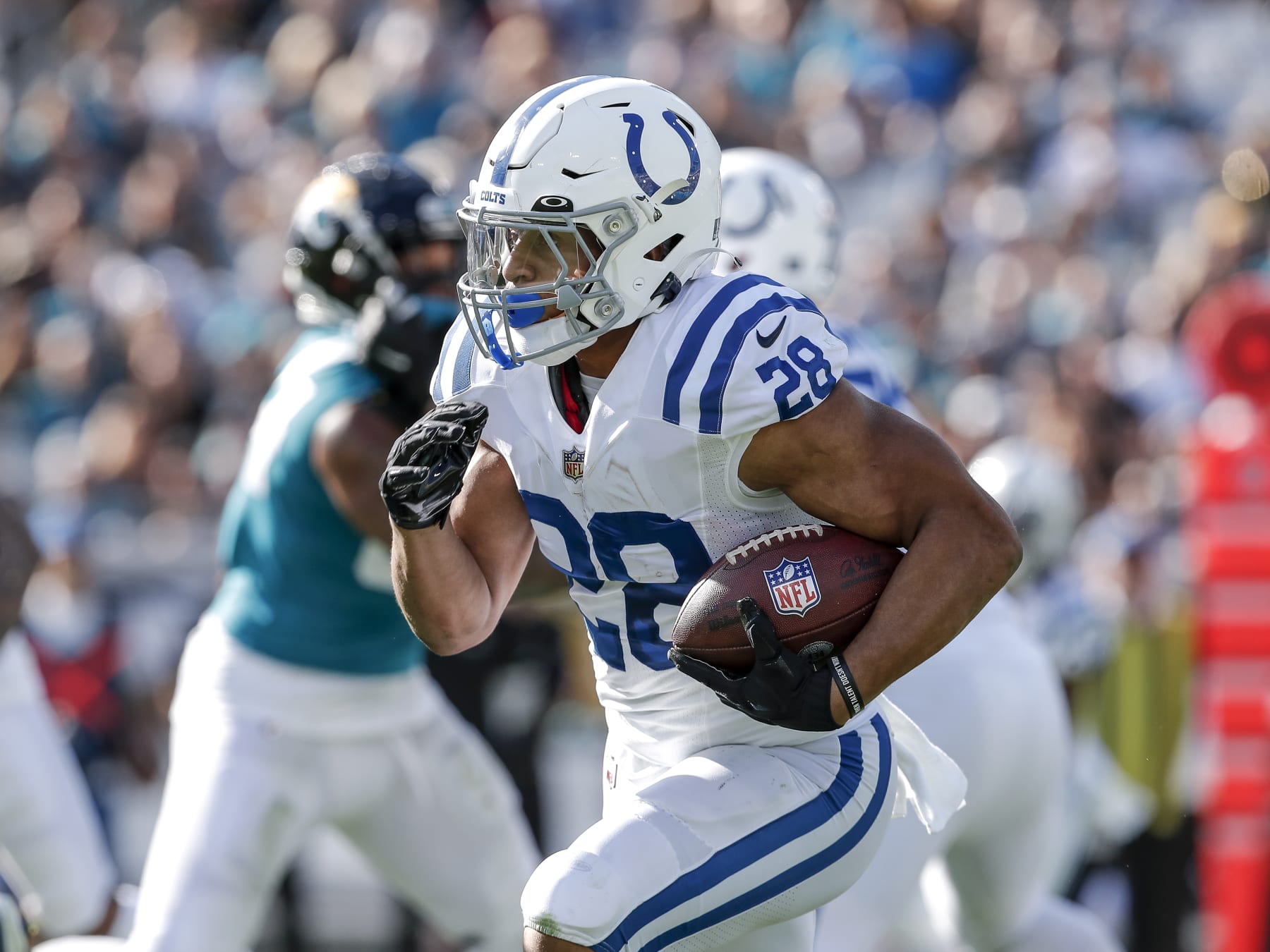JACKSONVILLE, FL - JANUARY 9: Running back Jonathan Taylor #28 of the Indianapolis Colts rushes against the Jacksonville Jaguars at TIAA Bank Field on January 9, 2022 in Jacksonville, Florida. The Jaguars won 26 -11. (Photo by Don Juan Moore/Getty Images)