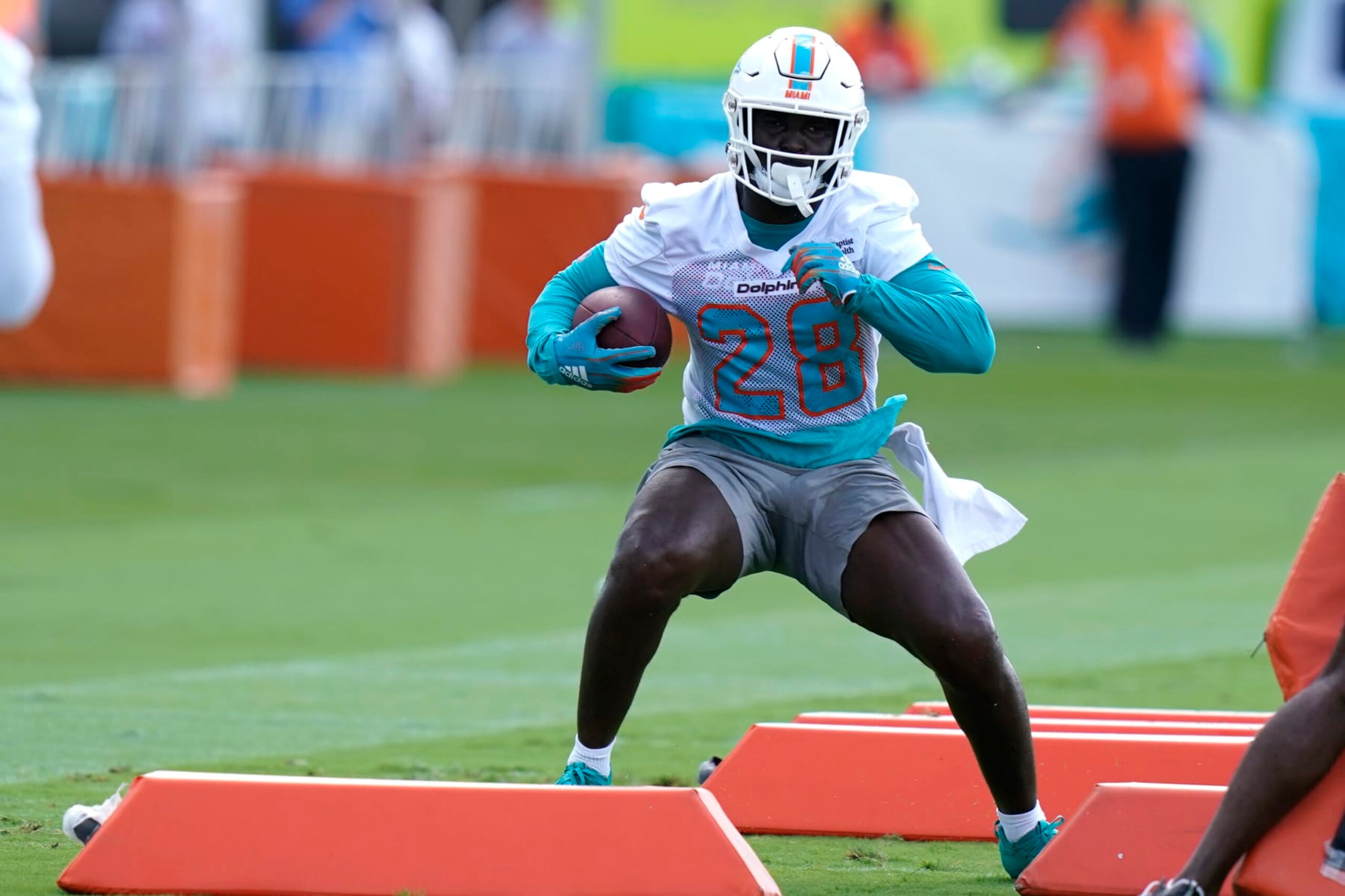 Miami Dolphins running back Sony Michel (28) takes part in drills at the NFL football team's practice facility, Tuesday, Aug. 16, 2022, in Miami Gardens, Fla. (AP Photo/Lynne Sladky)