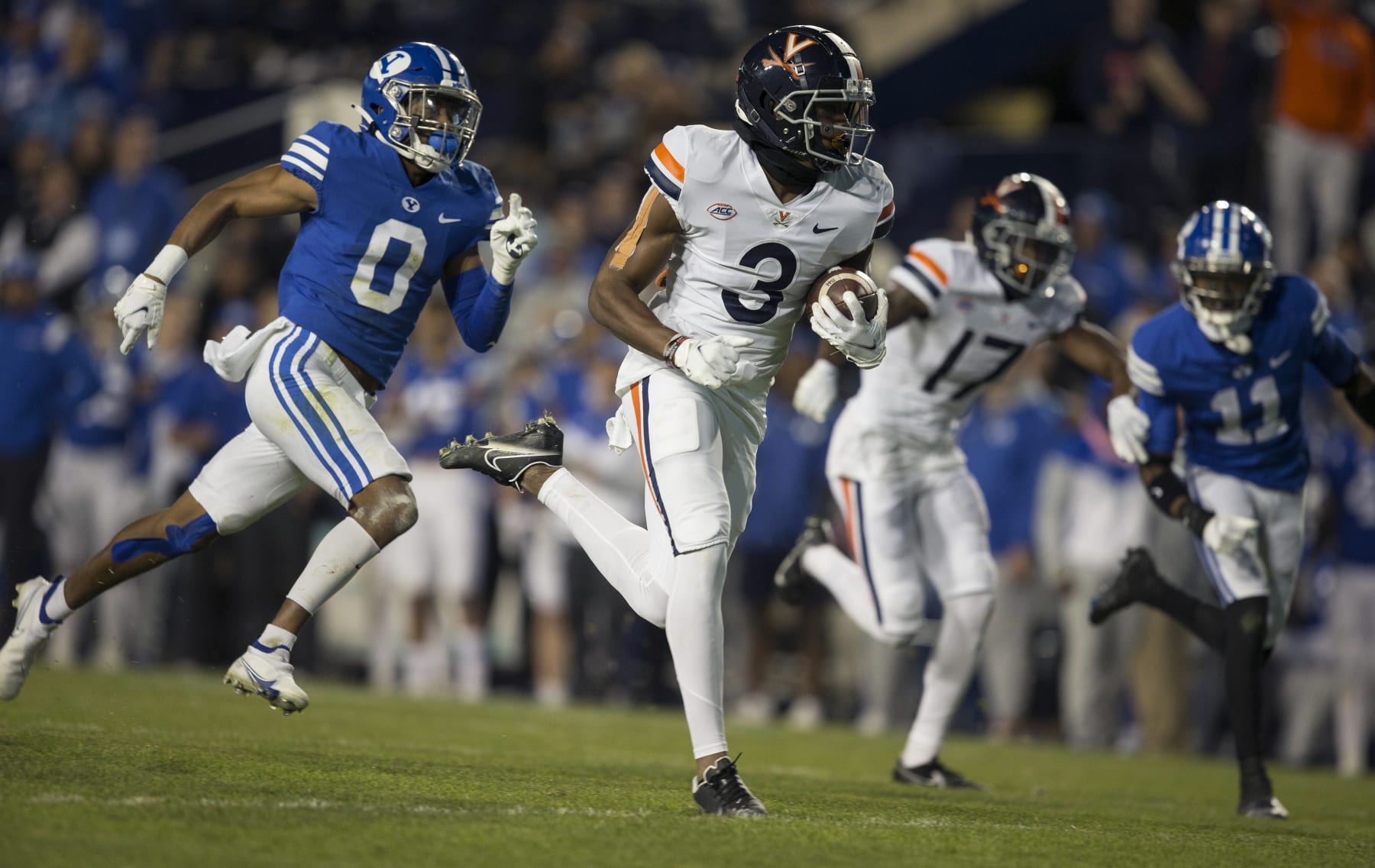 PROVO, UT -  OCTOBER 30:  Dontayvion Wicks #3 of the Virginia Cavaliers rushes for a touchdown past Jakob Robinson #0 and Isiah Herron #11 of the BYU Cougars during their game October 30, 2021 at the LaVell Edwards Stadium in Provo, Utah. (Photo by Chris Gardner/Getty Images)