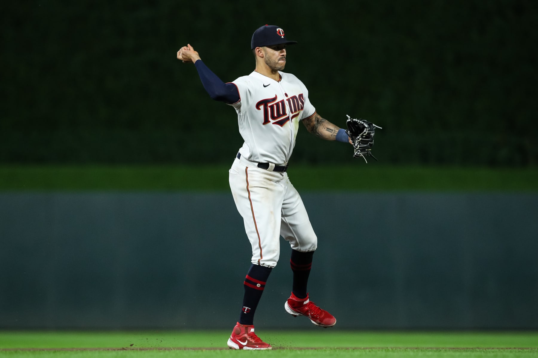 MINNEAPOLIS, MN - AUGUST 29: Carlos Correa #4 of the Minnesota Twins throws the ball to first base to get out Rafael Devers #11 of the Boston Red Sox in the seventh inning of the game at Target Field on August 29, 2022 in Minneapolis, Minnesota. The Twins defeated the Red Sox 4-2. (Photo by David Berding/Getty Images)