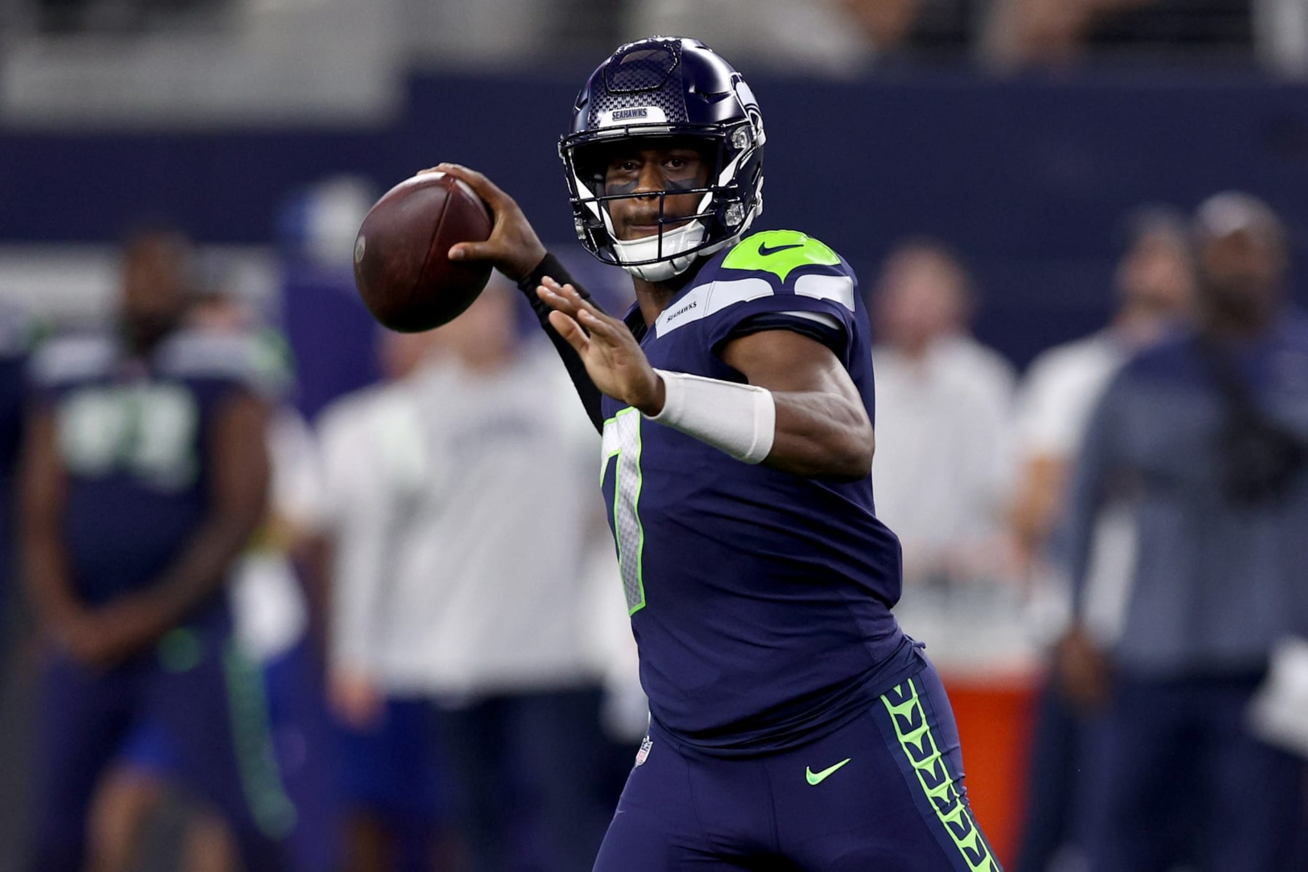 ARLINGTON, TEXAS - AUGUST 26: Quarterback Geno Smith #7 of the Seattle Seahawks looks for an open receiver against the Dallas Cowboys in the first quarter a NFL preseason football game at AT&T Stadium on August 26, 2022 in Arlington, Texas. (Photo by Tom Pennington/Getty Images)