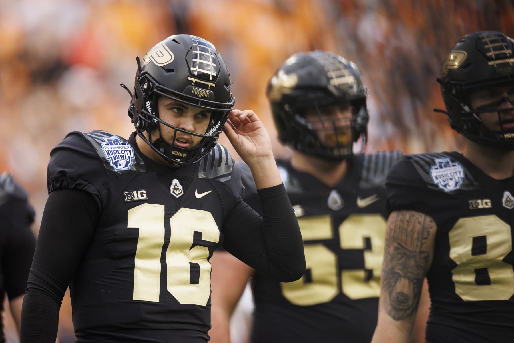 NASHVILLE, TN - DECEMBER 30:  Aidan O'Connell #16 of the Purdue Boilermakers walks off the field during the first quarter of the TransPerfect Music City Bowl against the Tennessee Volunteers at Nissan Stadium on December 30, 2021 in Nashville, Tennessee. Purdue defeats Tennessee 48-45 in overtime. (Photo by Brett Carlsen/Getty Images)