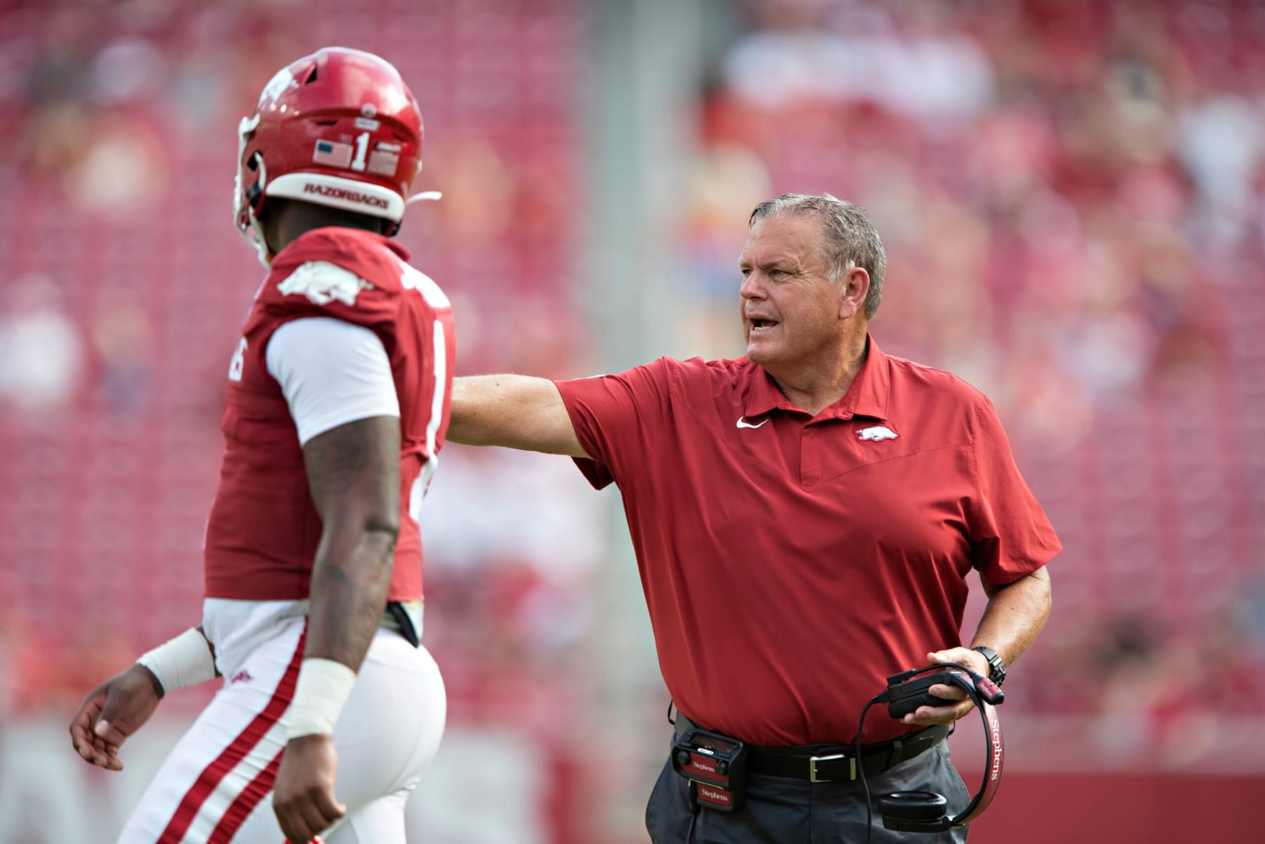 FAYETTEVILLE, AR - SEPTEMBER 4:  Head Coach Sam Pittman of the Arkansas Razorbacks talks during a timeout with KJ Jefferson #1 in the second half of a game against the Rice Owls at Donald W. Reynolds Razorback Stadium on September 4, 2021 in Fayetteville, Arkansas.  The Razorbacks defeated the Owls 38-17.  (Photo by Wesley Hitt/Getty Images)