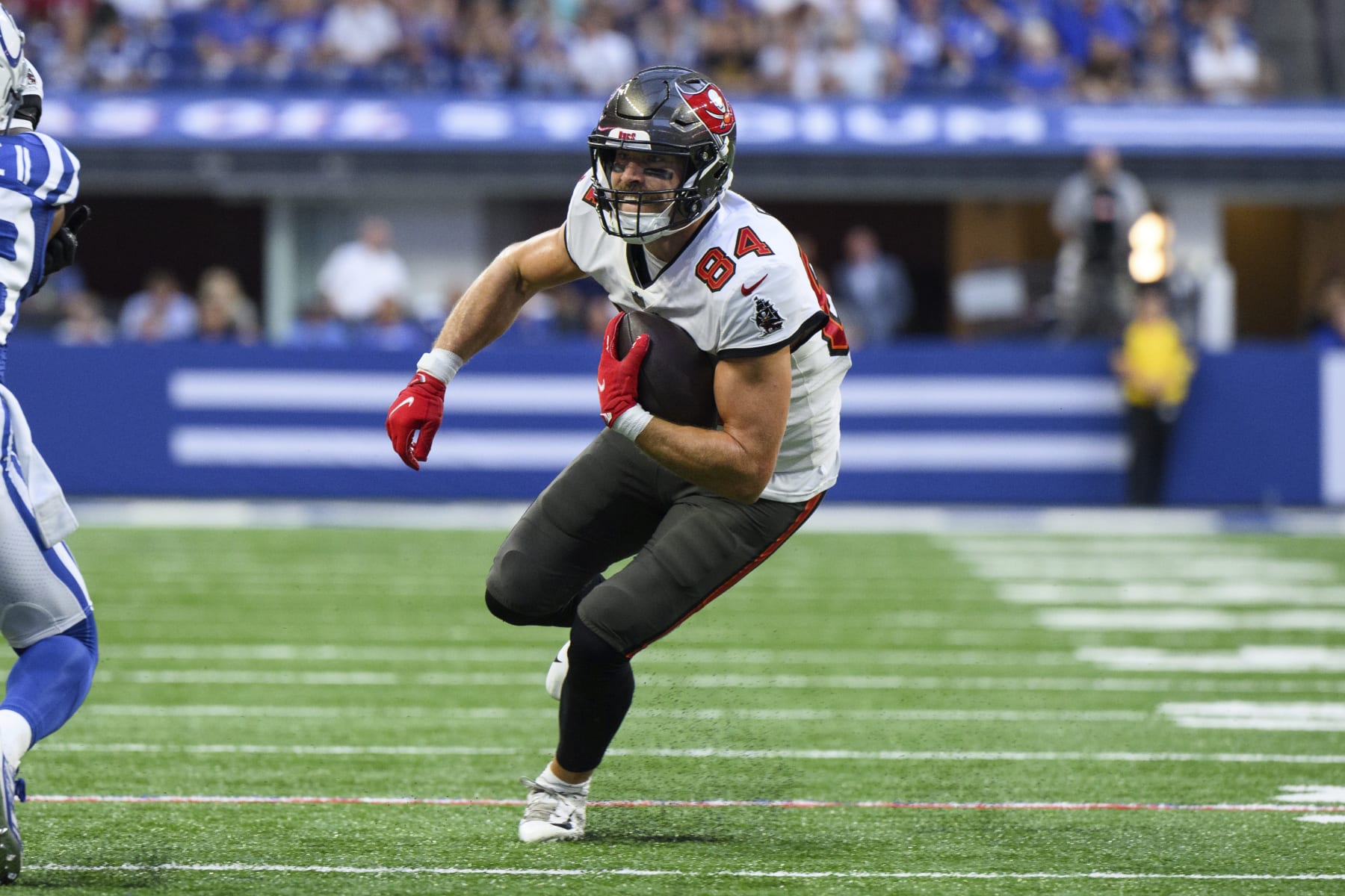 Tampa Bay Buccaneers tight end Cameron Brate (84) turns up the field after a catch during an NFL football game against the Indianapolis Colts, Saturday, Aug. 27, 2022, in Indianapolis. (AP Photo/Zach Bolinger)