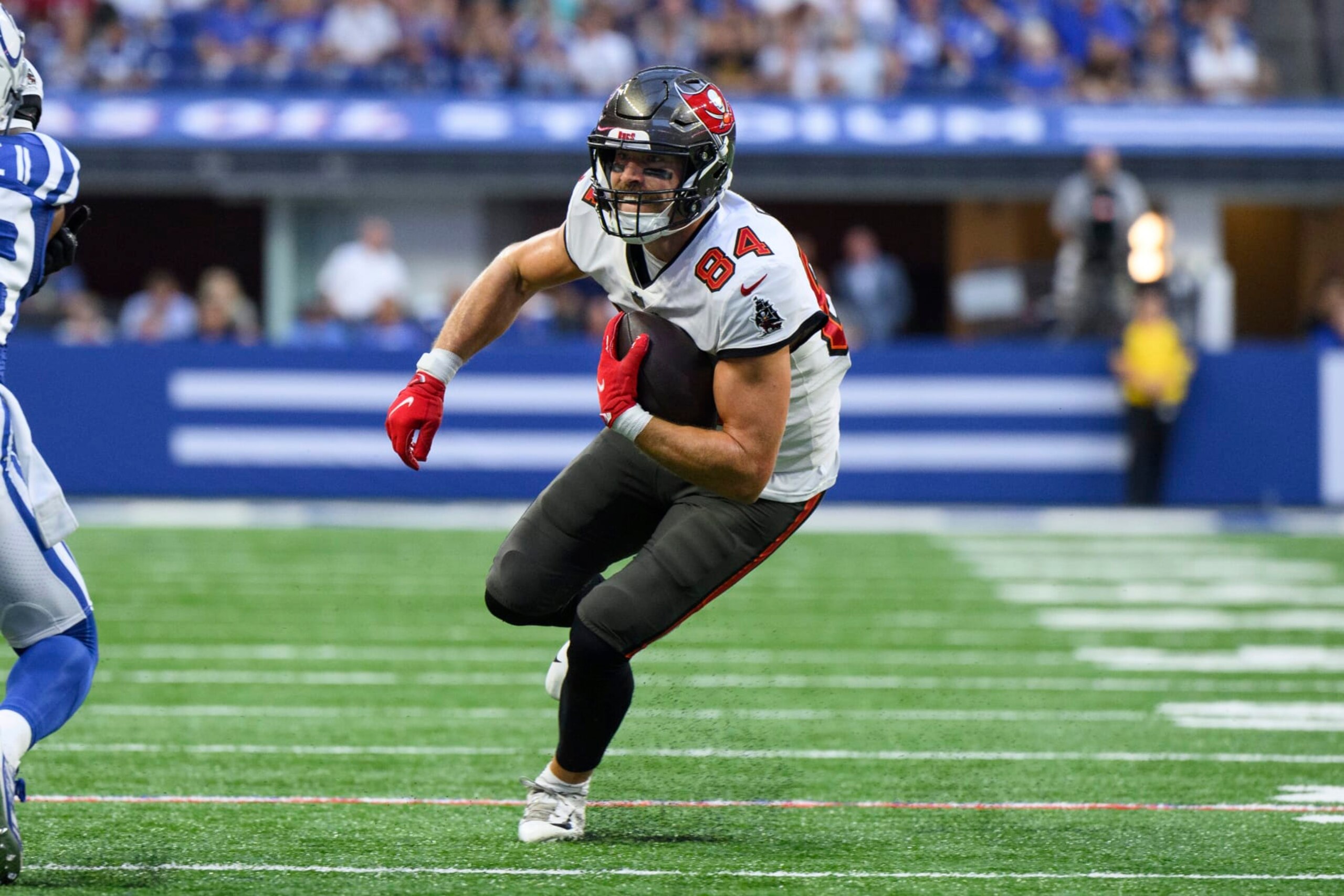 Tampa Bay Buccaneers tight end Cameron Brate (84) turns up the field after a catch during an NFL football game against the Indianapolis Colts, Saturday, Aug. 27, 2022, in Indianapolis. (AP Photo/Zach Bolinger)