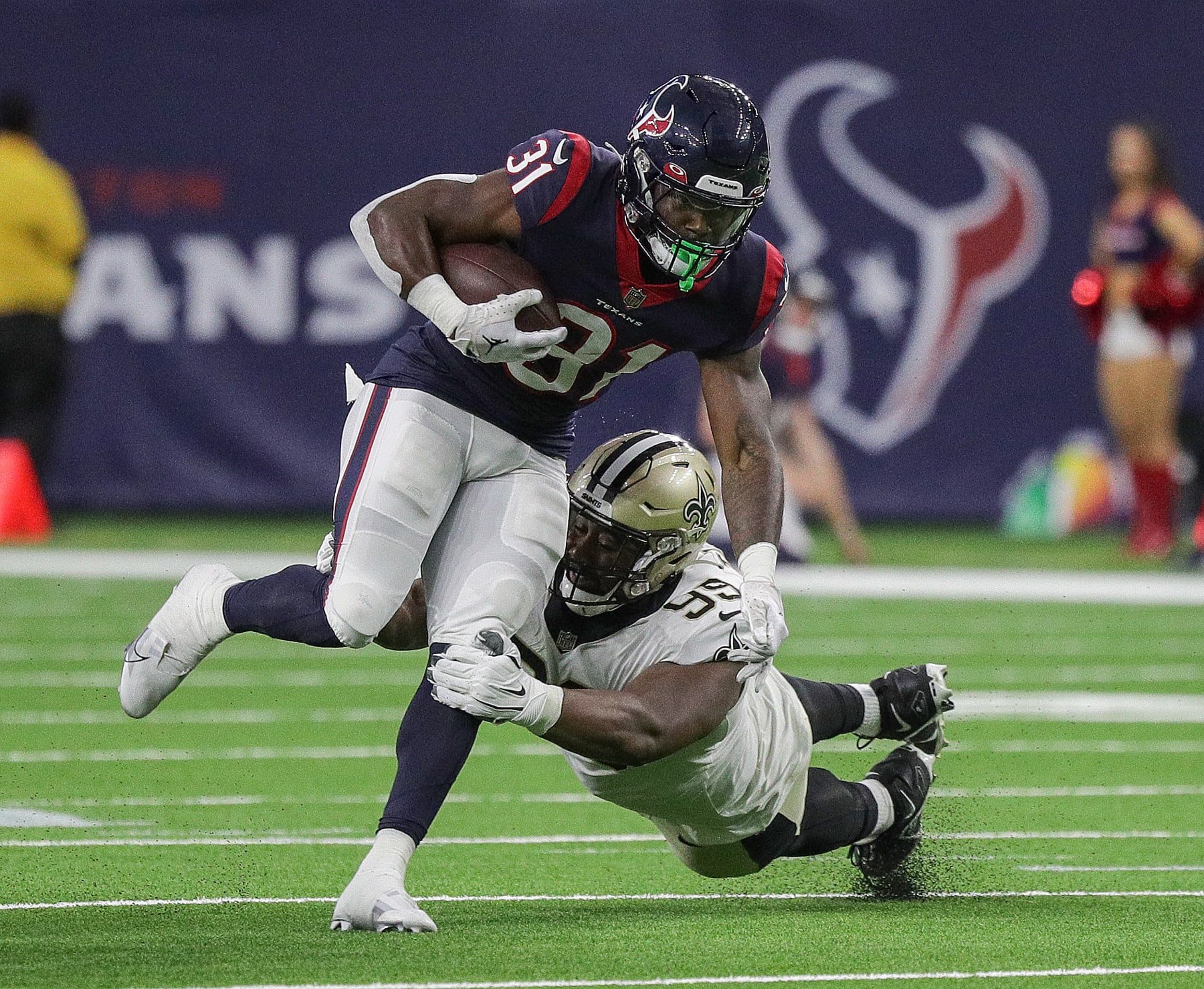HOUSTON, TEXAS - AUGUST 13: Dameon Pierce #31 of the Houston Texans breaks a tackle attempt by Shy Tuttle #99 of the New Orleans Saints in the first half in a preseason game at NRG Stadium on August 13, 2022 in Houston, Texas. (Photo by Bob Levey/Getty Images)