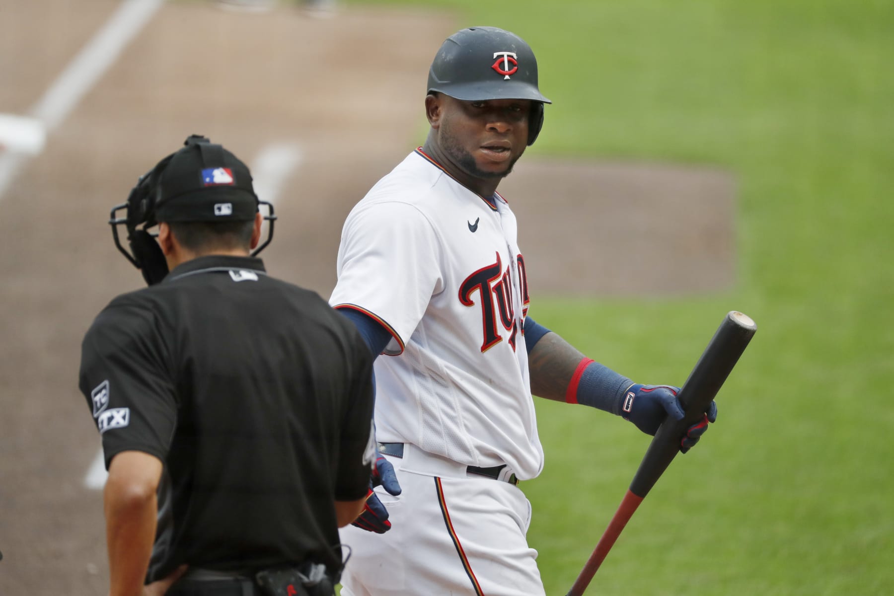 Minnesota Twins' Miguel Sano, right, has a few words with home plate umpire Gabe Morales after being called out on strikes against the Chicago White Sox in the seventh inning of a baseball game Saturday, April 23, 2022, in Minneapolis. (AP Photo/Bruce Kluckhohn)