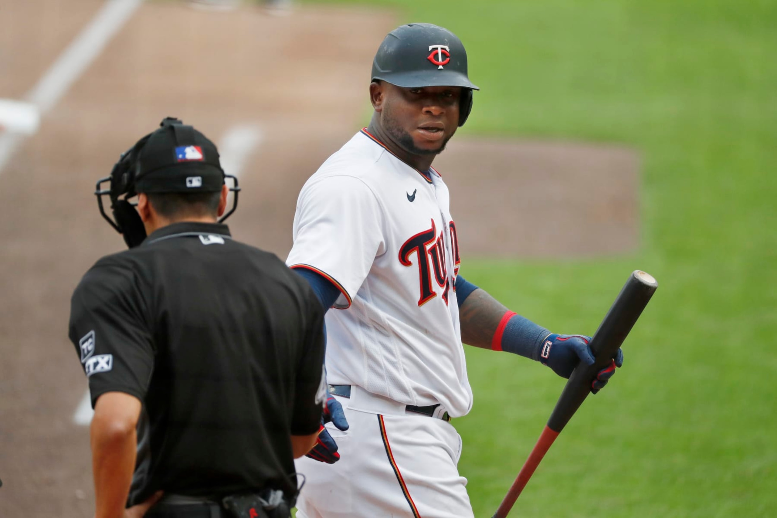 Minnesota Twins' Miguel Sano, right, has a few words with home plate umpire Gabe Morales after being called out on strikes against the Chicago White Sox in the seventh inning of a baseball game Saturday, April 23, 2022, in Minneapolis. (AP Photo/Bruce Kluckhohn)