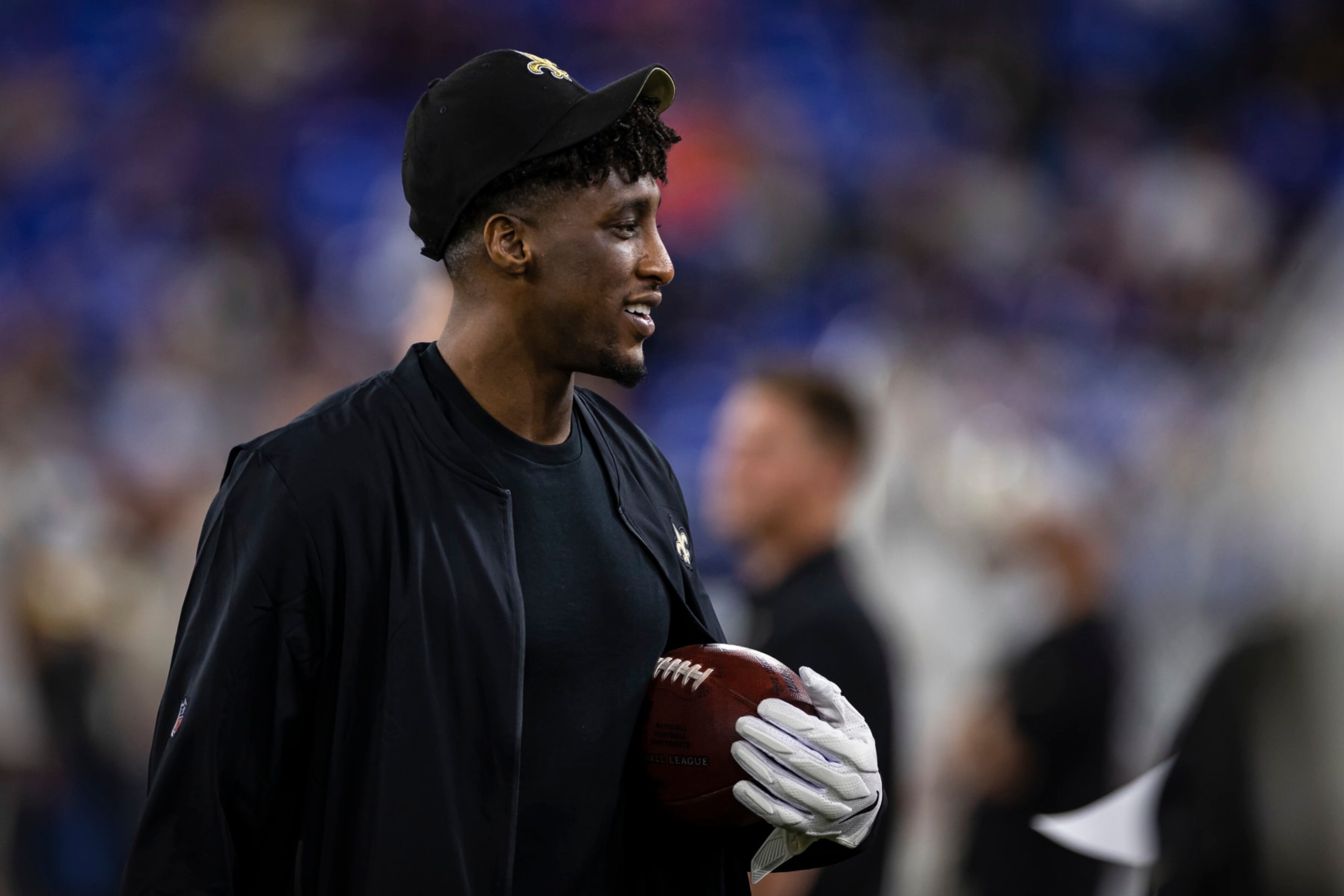 BALTIMORE, MD - AUGUST 14: Michael Thomas #13 of the New Orleans Saints hold a football on the sidelines while wearing receiver gloves in street clothes during the second half of a preseason game against the Baltimore Ravens at M&T Bank Stadium on August 14, 2021 in Baltimore, Maryland. (Photo by Scott Taetsch/Getty Images) BALTIMORE, MD - AUGUST 14: Michael Thomas #13 of the New Orleans Saints hold a football on the sidelines while wearing receiver gloves in street clothes during the second half of a preseason game against the Baltimore Ravens at M&T Bank Stadium on August 14, 2021 in Baltimore, Maryland. (Photo by Scott Taetsch/Getty Images)