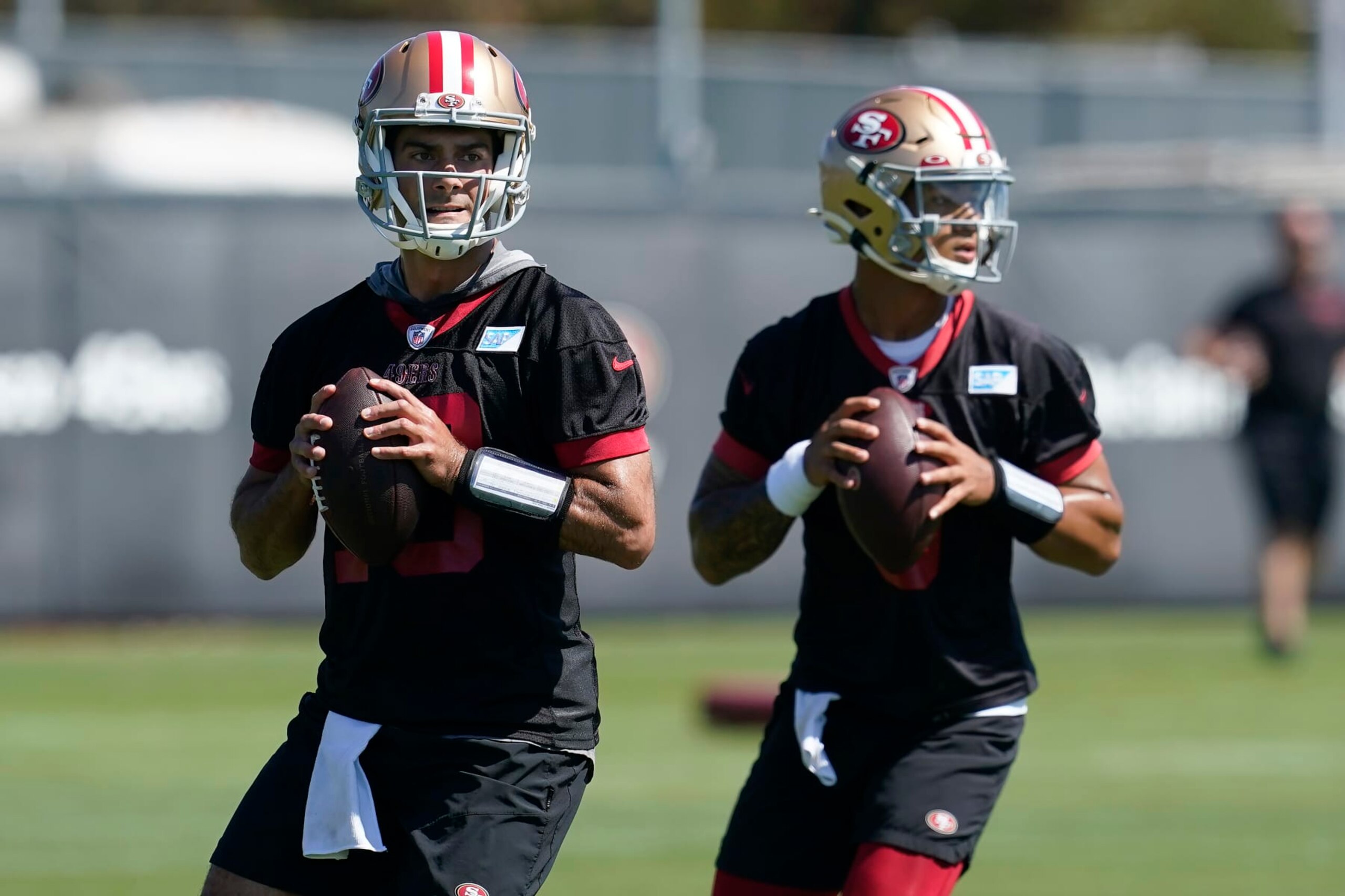 San Francisco 49ers quarterbacks Jimmy Garoppolo, left, and Trey Lance take part in drills at the NFL football team's practice facility in Santa Clara, Calif., Thursday, Sept. 1, 2022. (AP Photo/Jeff Chiu)