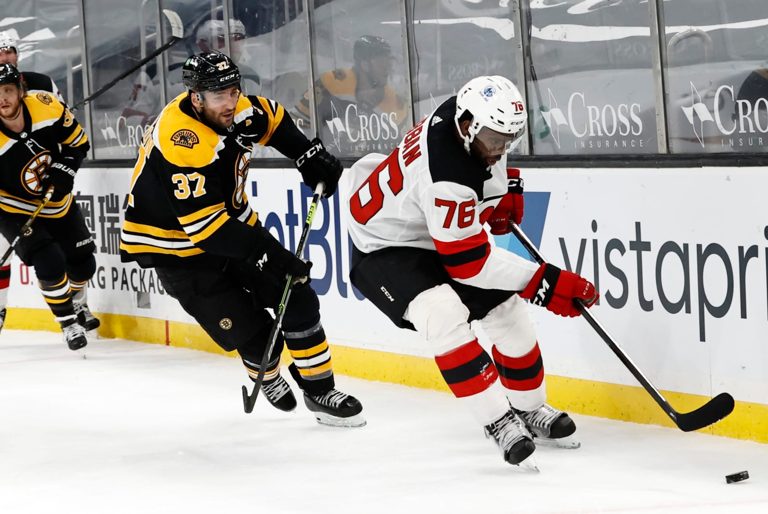BOSTON, MA - MARCH 28: Boston Bruins center Patrice Bergeron (37) chases New Jersey Devils defenseman P.K. Subban (76) into the corner during a game between the Boston Bruins and the New Jersey Devils on March 28, 2021, at TD Garden in Boston, Massachusetts. (Photo by Fred Kfoury III/Icon Sportswire via Getty Images)