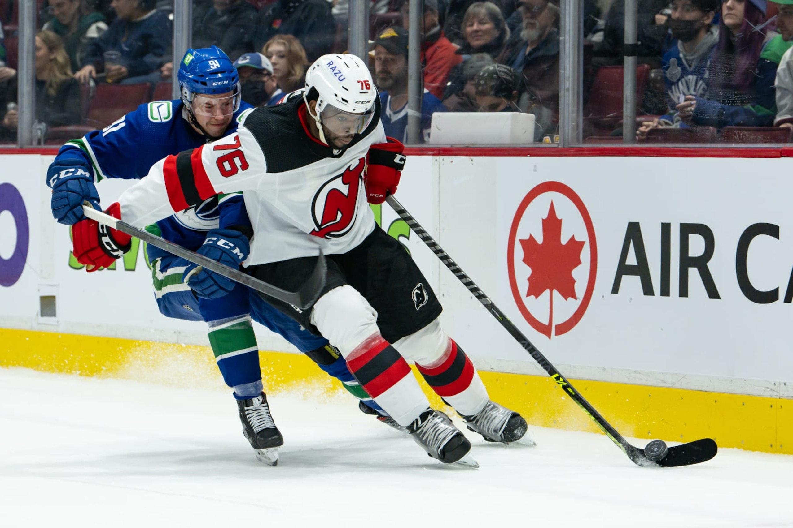 VANCOUVER, BC - MARCH 15: New Jersey Devils defenseman P.K. Subban (76) is checked by Vancouver Canucks right wing Juho Lammikko (91) during their NHL game at Rogers Arena on March 15, 2022 in Vancouver, British Columbia, Canada. (Photo by Derek Cain/Icon Sportswire via Getty Images)