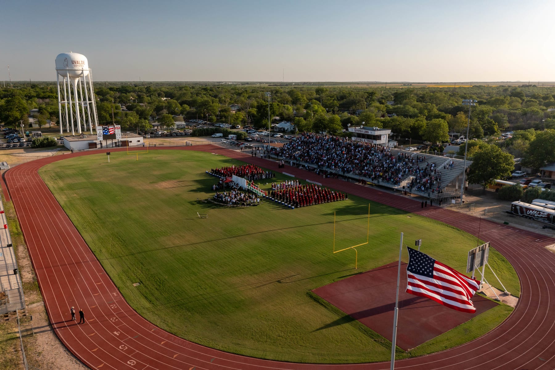 UVALDE, TX - JUNE 24: In this aerial view, members of the community participate in the Uvalde High School graduation ceremony  on June 24, 2022 in Uvalde, Texas.  Nearly 300 Uvalde High School seniors received their diplomas one month to the day after nineteen children and two adults were killed at Robb Elementary School after a former student entered the school and barricaded himself in a classroom.  (Photo by Jordan Vonderhaar/Getty Images)