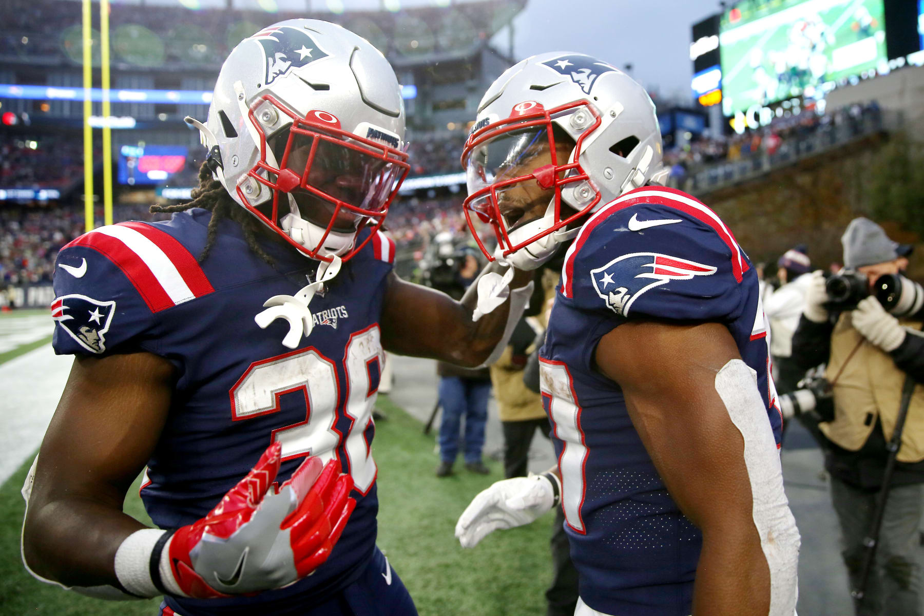 FOXBOROUGH, MASSACHUSETTS - NOVEMBER 28: Damien Harris #37 of the New England Patriots celebrates with Rhamondre Stevenson #38 after scoring a rushing touchdown against the Tennessee Titans in the fourth quarter at Gillette Stadium on November 28, 2021 in Foxborough, Massachusetts. (Photo by Adam Glanzman/Getty Images)