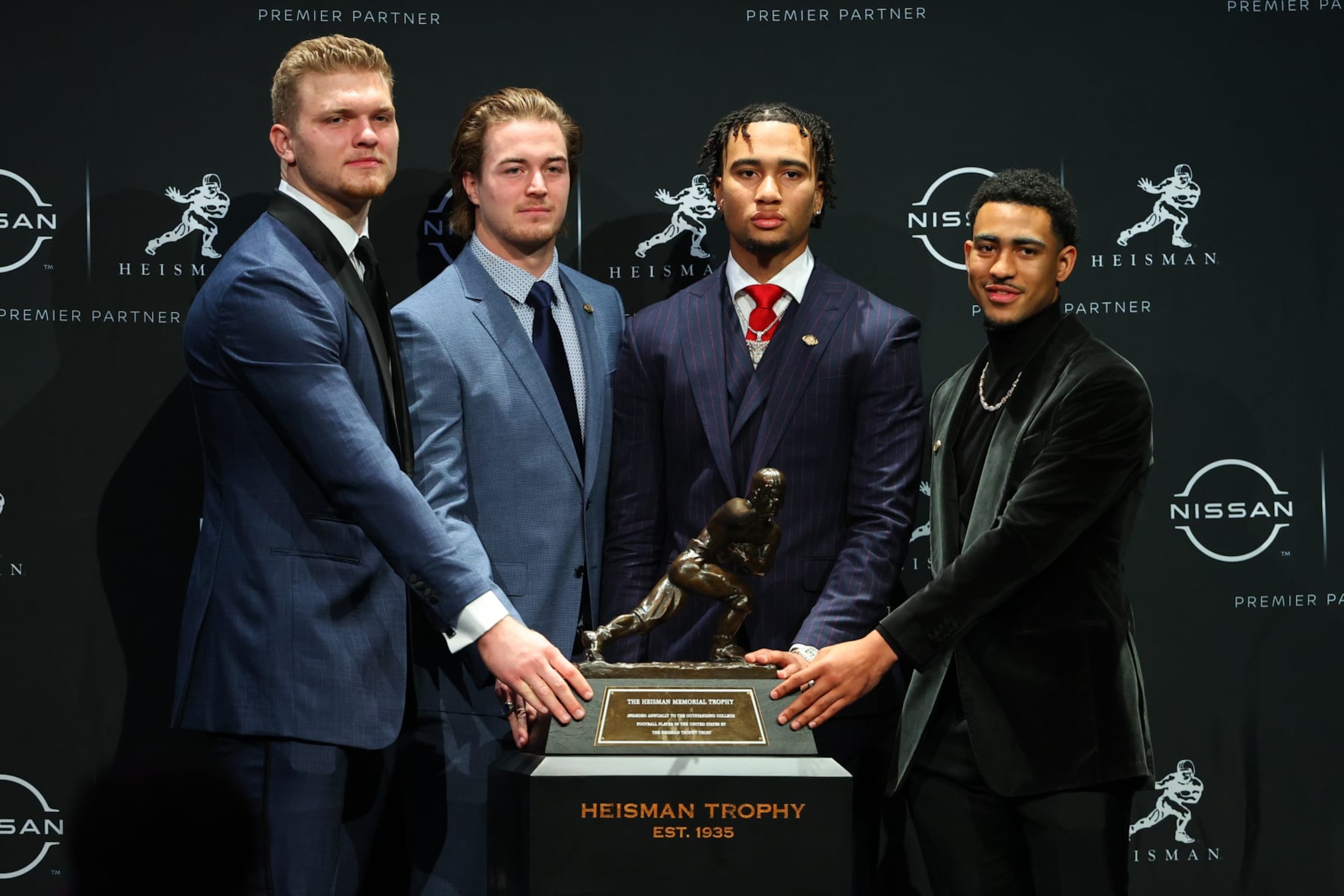 NEW YORK, NY - DECEMBER 11: The Heisman Trophy finalists defensive end Aidan Hutchinson from Michigan, quarterback Kenny Pickett from Pittsburgh, quarterback C.J. Stroud from Ohio State and quarterback Bryce Young from Alabama look serious as they pose with the Heisman Trophy at  the Marriott Marquis in New York on December 11, 2021 in New  York City, NY.  (Photo by Rich Graessle/Icon Sportswire via Getty Images)
