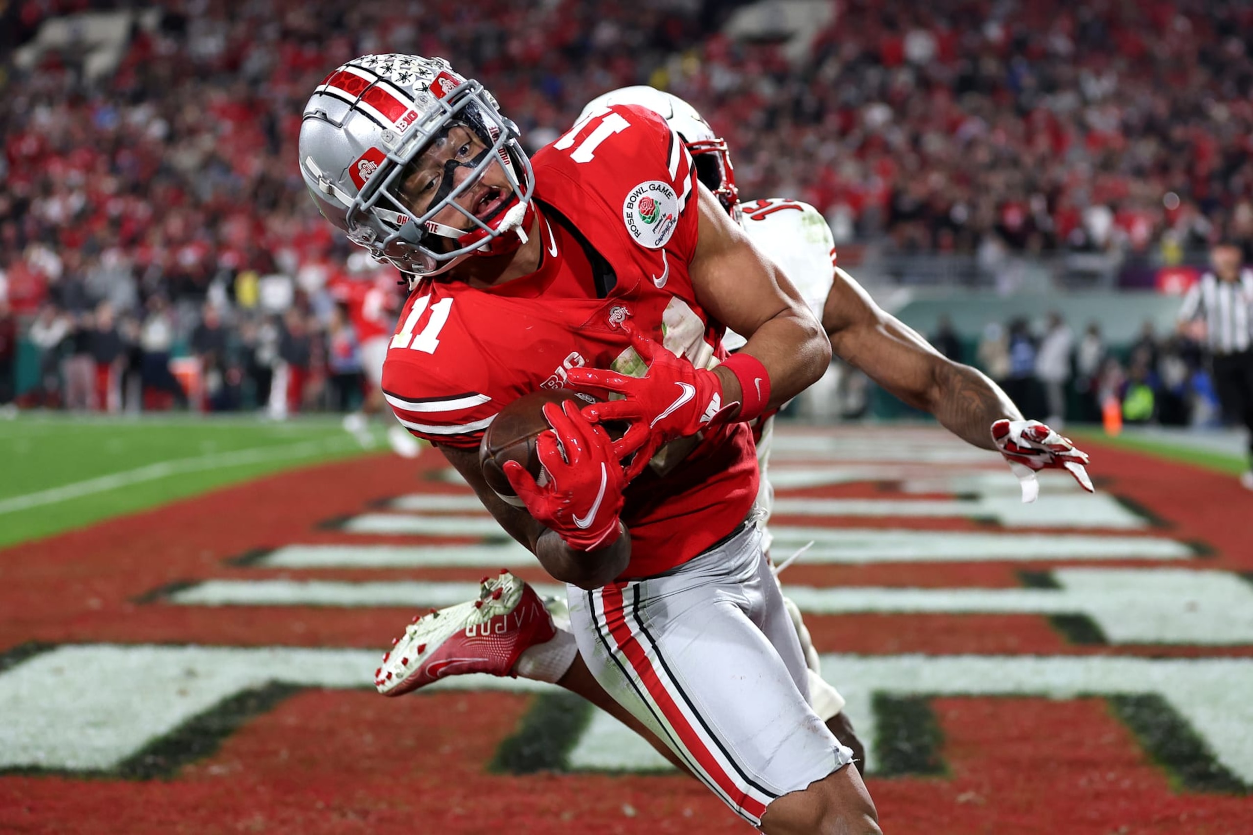 PASADENA, CALIFORNIA - JANUARY 01: Jaxon Smith-Njigba #11 of the Ohio State Buckeyes catches a touchdown pass as Malone Mataele #15 of the Utah Utes defends during the fourth quarter in the Rose Bowl Game at Rose Bowl Stadium on January 01, 2022 in Pasadena, California. (Photo by Sean M. Haffey/Getty Images)