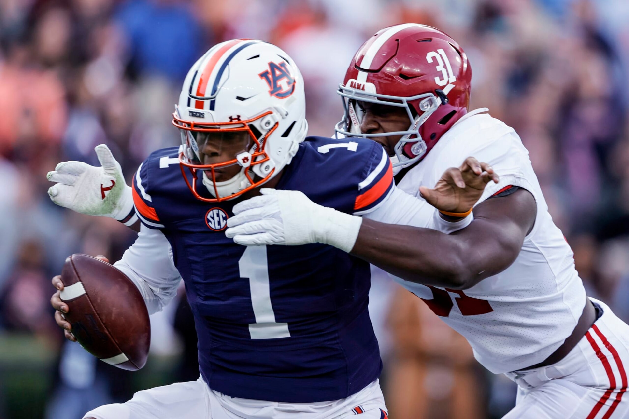 FILE - Alabama linebacker Will Anderson Jr. (31) sacks Auburn quarterback TJ Finley (1) during the first half of an NCAA college football game Saturday, Nov. 27, 2021, in Auburn, Ala. Alabama plays Georgia in the College Football Playoff national championship game on Jan. 10, 2022. (AP Photo/Butch Dill, File) FILE - Alabama linebacker Will Anderson Jr. (31) sacks Auburn quarterback TJ Finley (1) during the first half of an NCAA college football game Saturday, Nov. 27, 2021, in Auburn, Ala. Alabama plays Georgia in the College Football Playoff national championship game on Jan. 10, 2022. (AP Photo/Butch Dill, File)