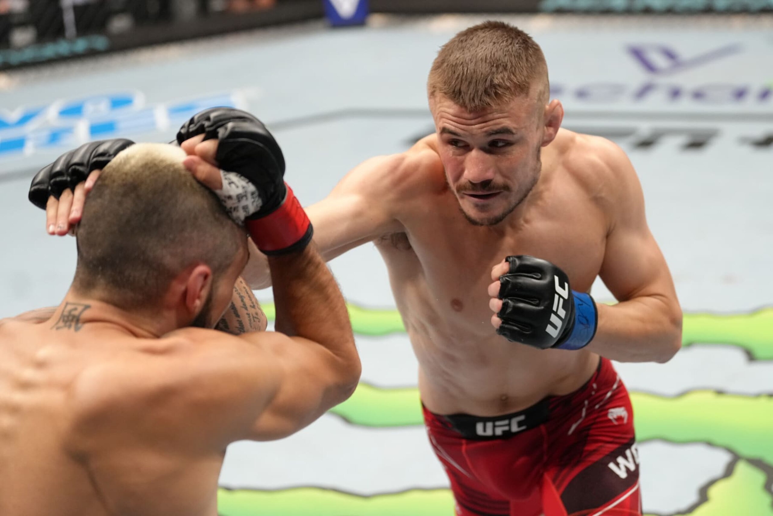 PARIS, FRANCE - SEPTEMBER 03: (R-L) Nathaniel Wood of England punches Charles Jourdain of Canada in a featherweight fight during the UFC Fight Night event at The Accor Arena on September 03, 2022 in Paris, France. (Photo by Jeff Bottari/Zuffa LLC)