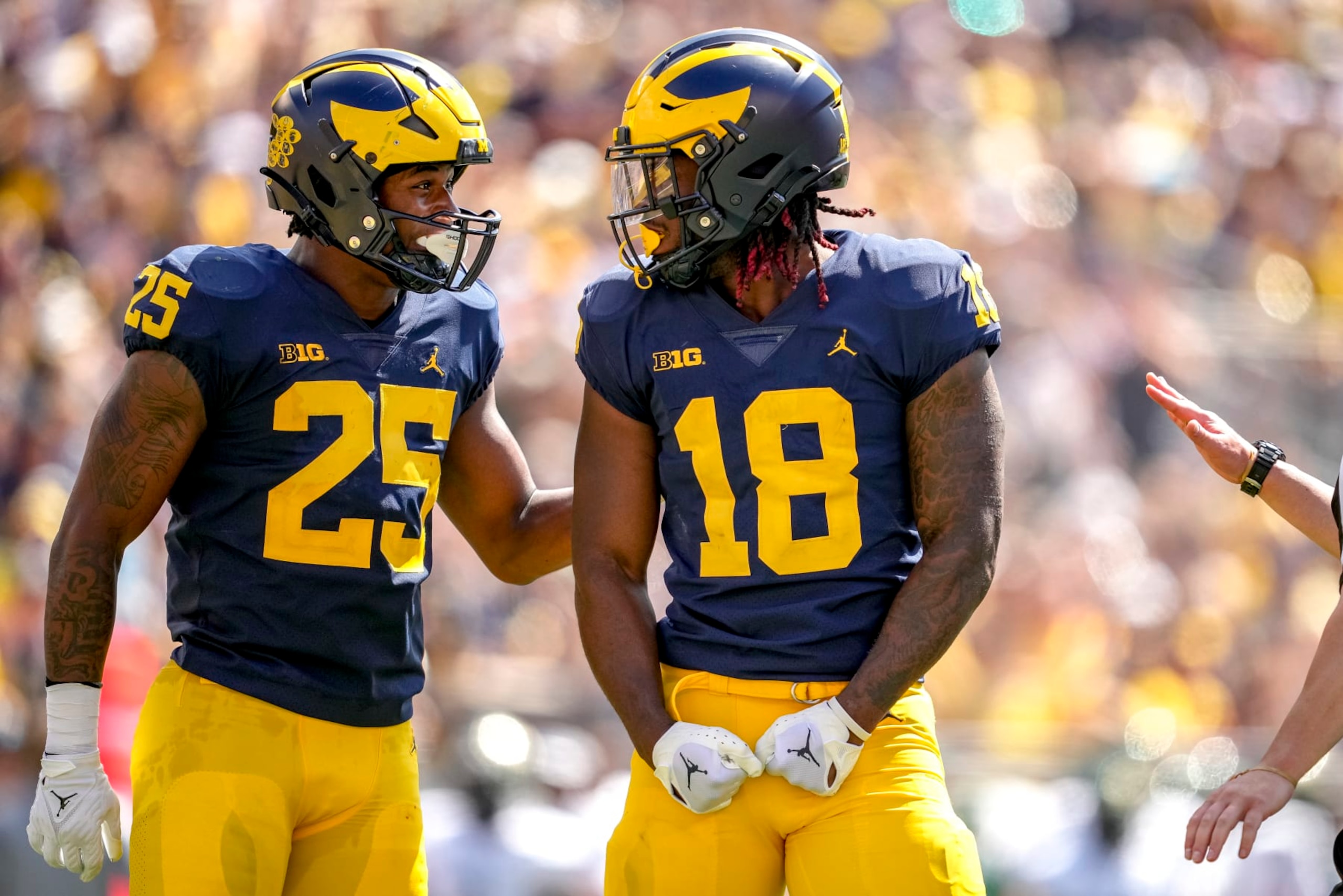 ANN ARBOR, MICHIGAN - SEPTEMBER 03: Junior Colson #25 of the Michigan Wolverines and Eyabi Anoma #18 of the Michigan Wolverines celebrate against the Colorado State Rams during the first half at Michigan Stadium on September 03, 2022 in Ann Arbor, Michigan. (Photo by Nic Antaya/Getty Images)