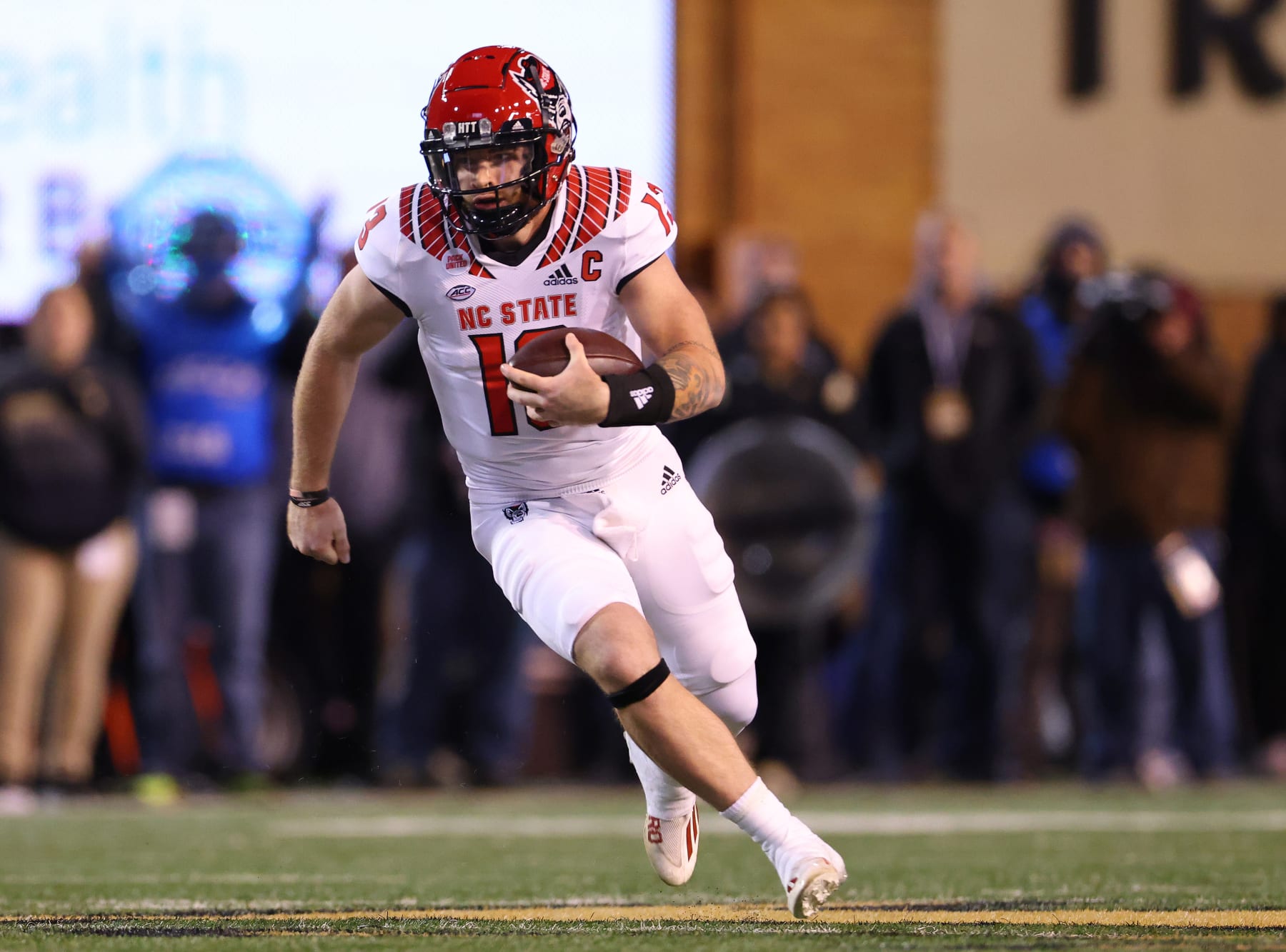 WINSTON-SALEM, NORTH CAROLINA - NOVEMBER 13: Devin Leary #13 of the North Carolina State Wolfpack runs against the Wake Forest Demon Deacons during their game at Truist Field on November 13, 2021 in Winston-Salem, North Carolina. Wake Forest won 45-42. (Photo by Grant Halverson/Getty Images)