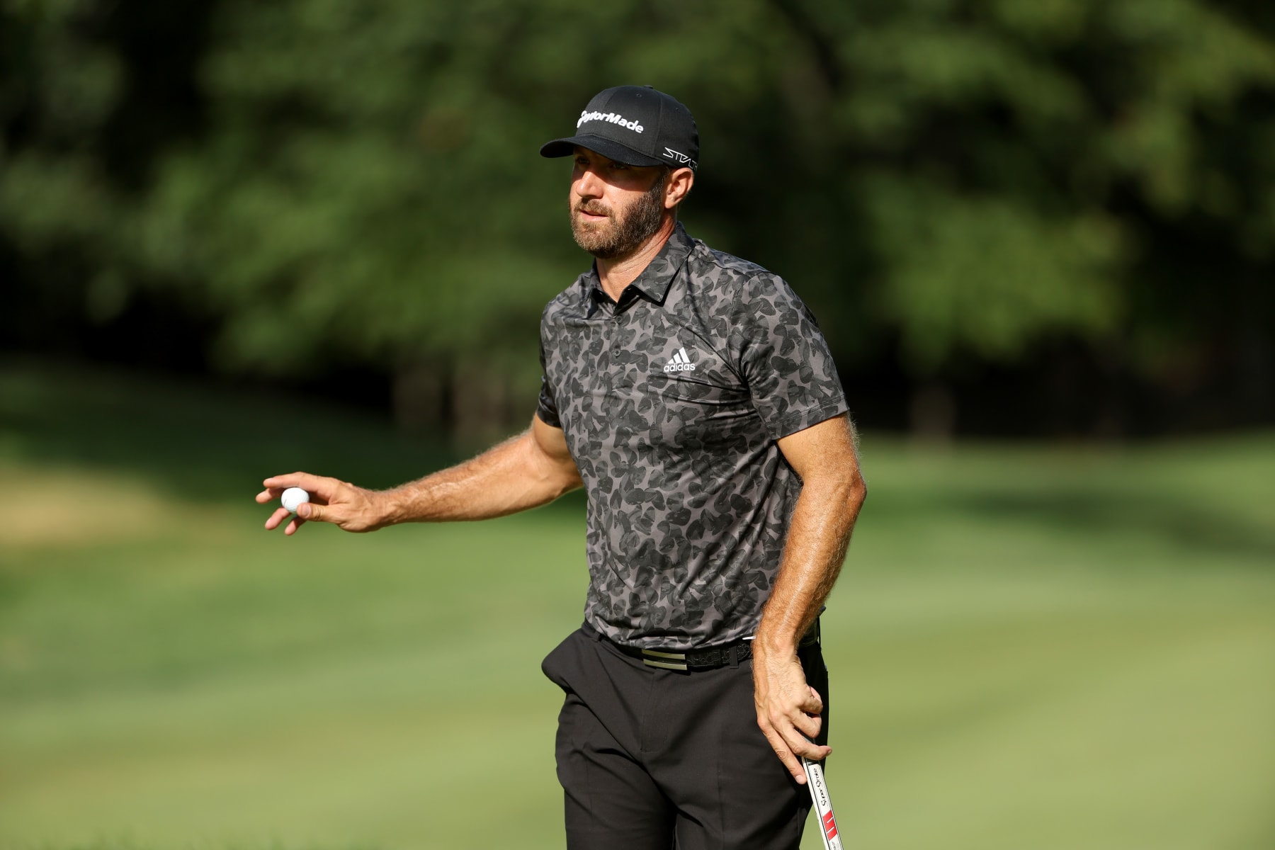 BOLTON, MASSACHUSETTS - SEPTEMBER 03: Team Captain Dustin Johnson of 4 Aces GC acknowledges the gallery after a putt during Day Two of the LIV Golf Invitational - Boston at The Oaks golf course at The International on September 03, 2022 in Bolton, Massachusetts. (Photo by Patrick Smith/LIV Golf via Getty Images)
