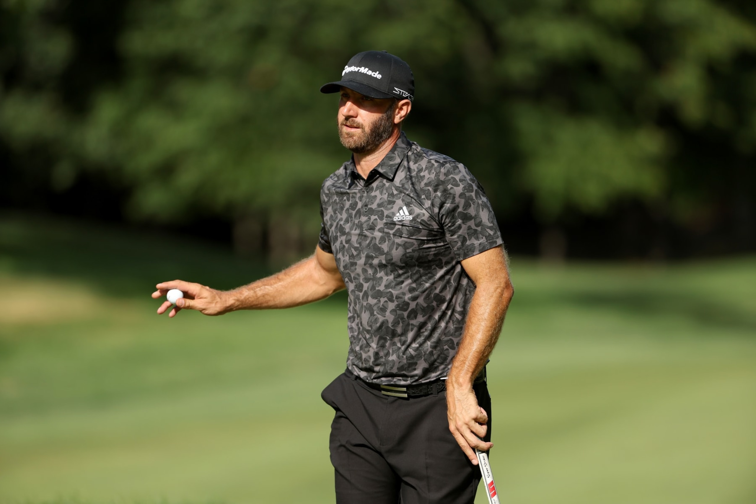 BOLTON, MASSACHUSETTS - SEPTEMBER 03: Team Captain Dustin Johnson of 4 Aces GC acknowledges the gallery after a putt during Day Two of the LIV Golf Invitational - Boston at The Oaks golf course at The International on September 03, 2022 in Bolton, Massachusetts. (Photo by Patrick Smith/LIV Golf via Getty Images)