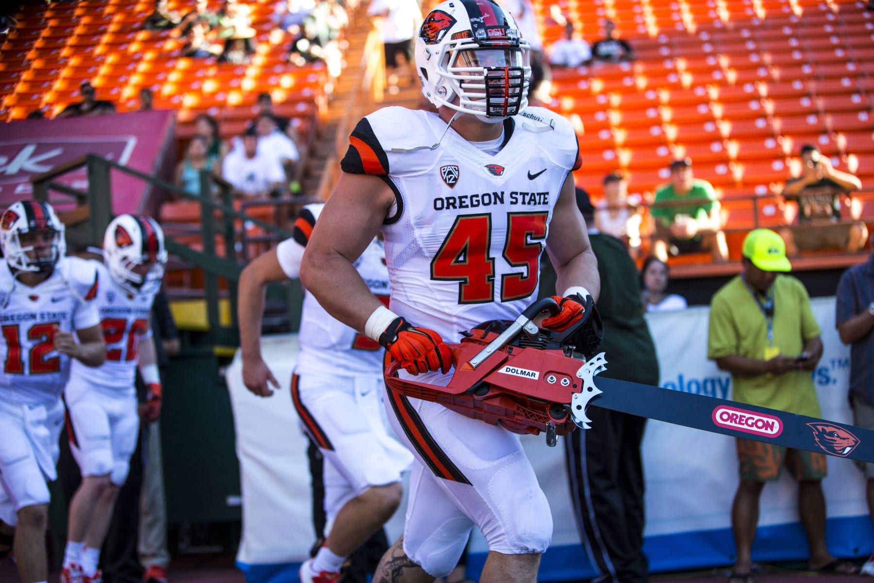 HONOLULU, HI - SEPTEMBER 06:  Dylan Wynn #45 of the Oregon State Beavers carries a chainsaw while running out of a tunnel onto the field before the start of the first quarter of a college football game between the Oregon State Beavers and the Hawaii Warriors at Aloha Stadium on September 06, 2014 in Honolulu, Hawaii.  The Oregon State Beavers defeated the Hawaii Warriors 38-30.  The Oregon State Beavers defeated the Hawaii Warriors 38-30.  (Photo by Kent Nishimura/Getty Images)