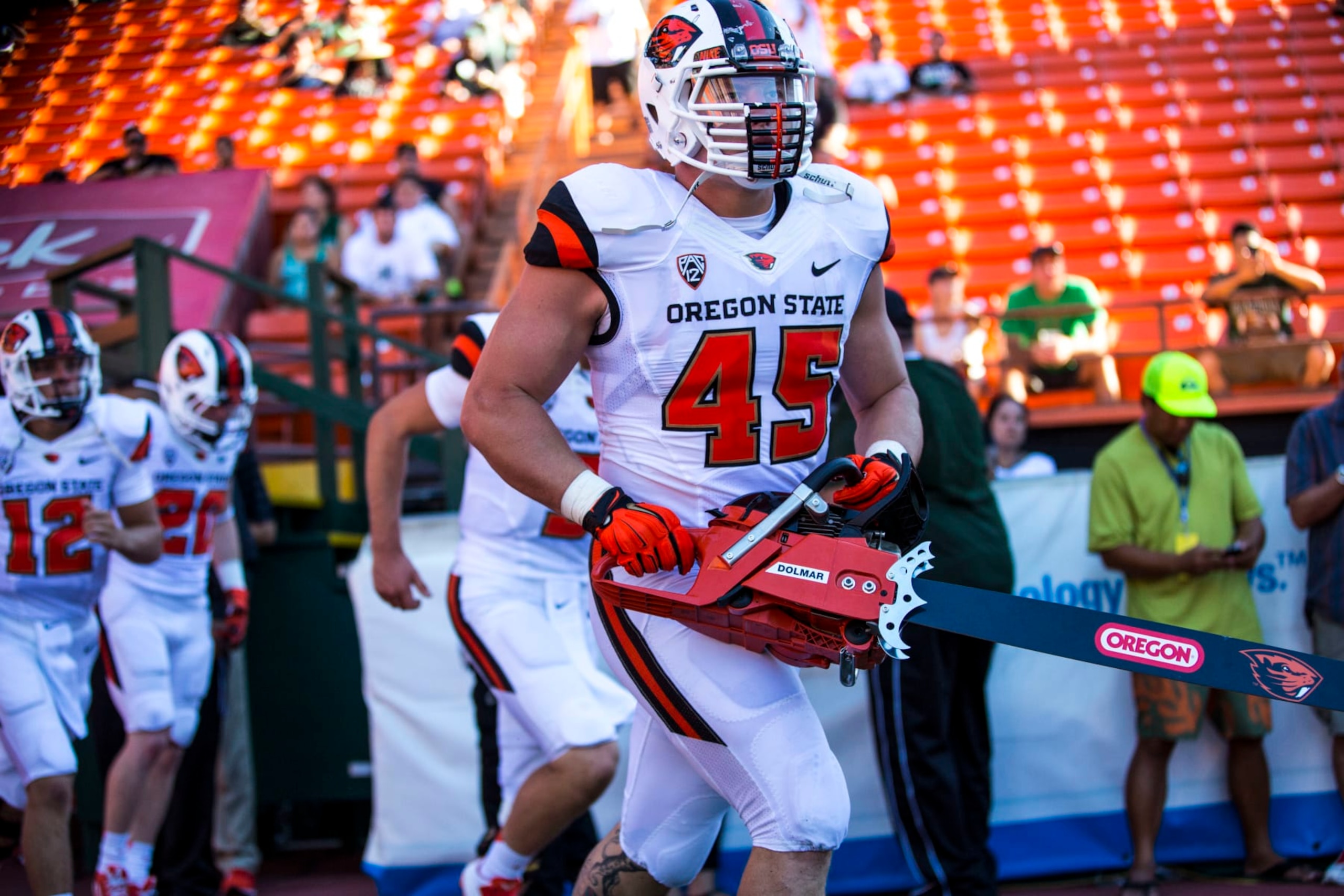 HONOLULU, HI - SEPTEMBER 06:  Dylan Wynn #45 of the Oregon State Beavers carries a chainsaw while running out of a tunnel onto the field before the start of the first quarter of a college football game between the Oregon State Beavers and the Hawaii Warriors at Aloha Stadium on September 06, 2014 in Honolulu, Hawaii.  The Oregon State Beavers defeated the Hawaii Warriors 38-30.  The Oregon State Beavers defeated the Hawaii Warriors 38-30.  (Photo by Kent Nishimura/Getty Images)