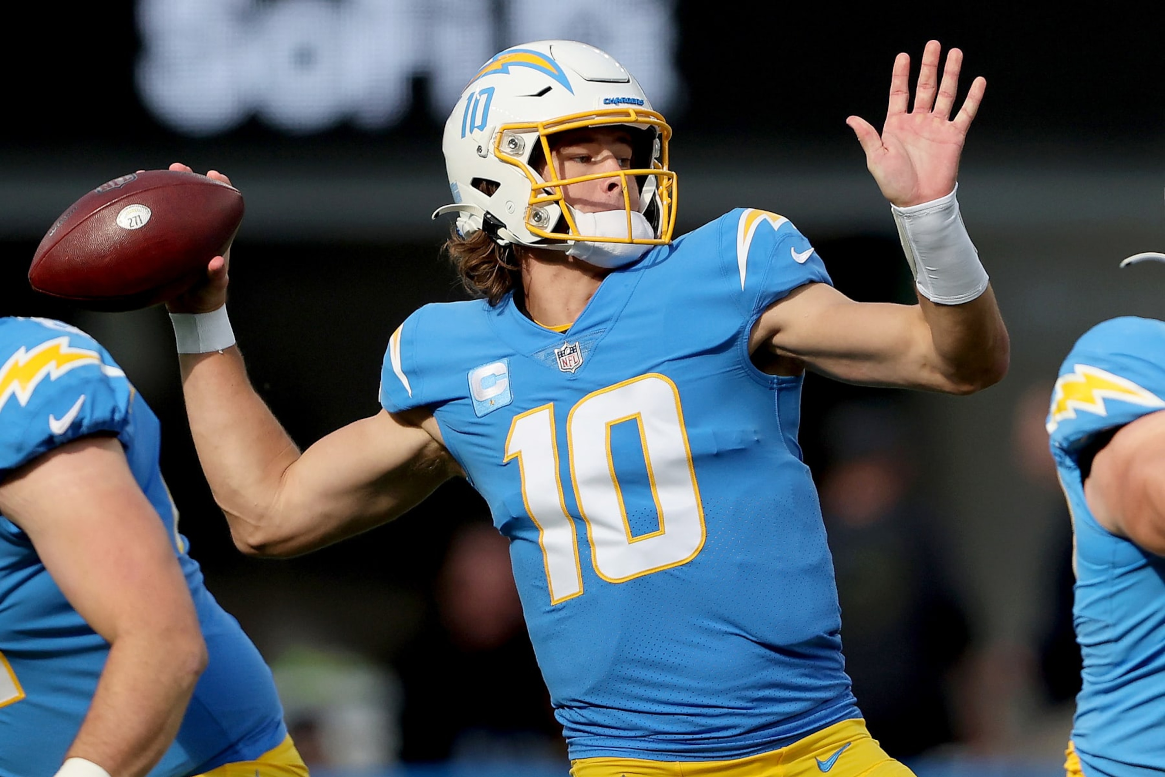 INGLEWOOD, CALIFORNIA - JANUARY 02: Justin Herbert #10 of the Los Angeles Chargers delivers a pass over the defense of the Denver Broncos in the first quarter of the game at SoFi Stadium on January 02, 2022 in Inglewood, California. (Photo by Sean M. Haffey/Getty Images)
