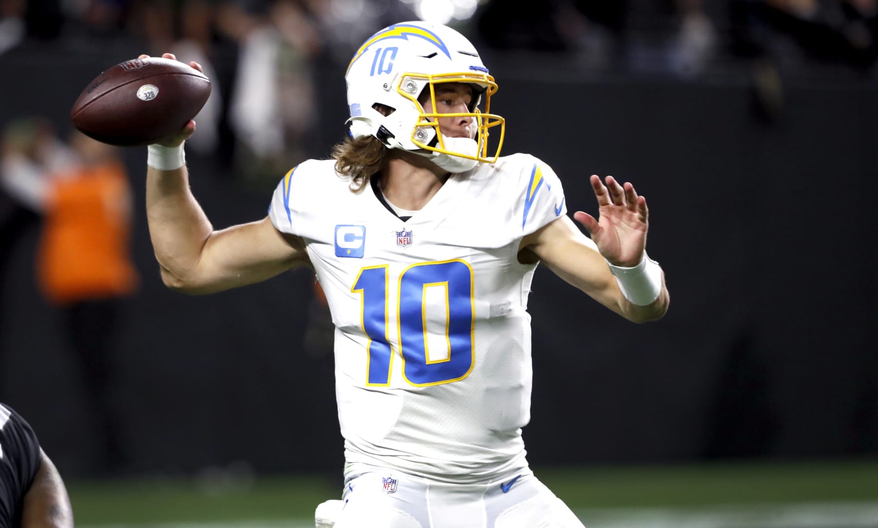 LAS VEGAS, NEVADA - JANUARY 09: Quarterback Justin Herbert #10 of the Los Angeles Chargers passes against the Las Vegas Raiders at Allegiant Stadium on January 09, 2022 in Las Vegas, Nevada. (Photo by Steve Marcus/Getty Images)