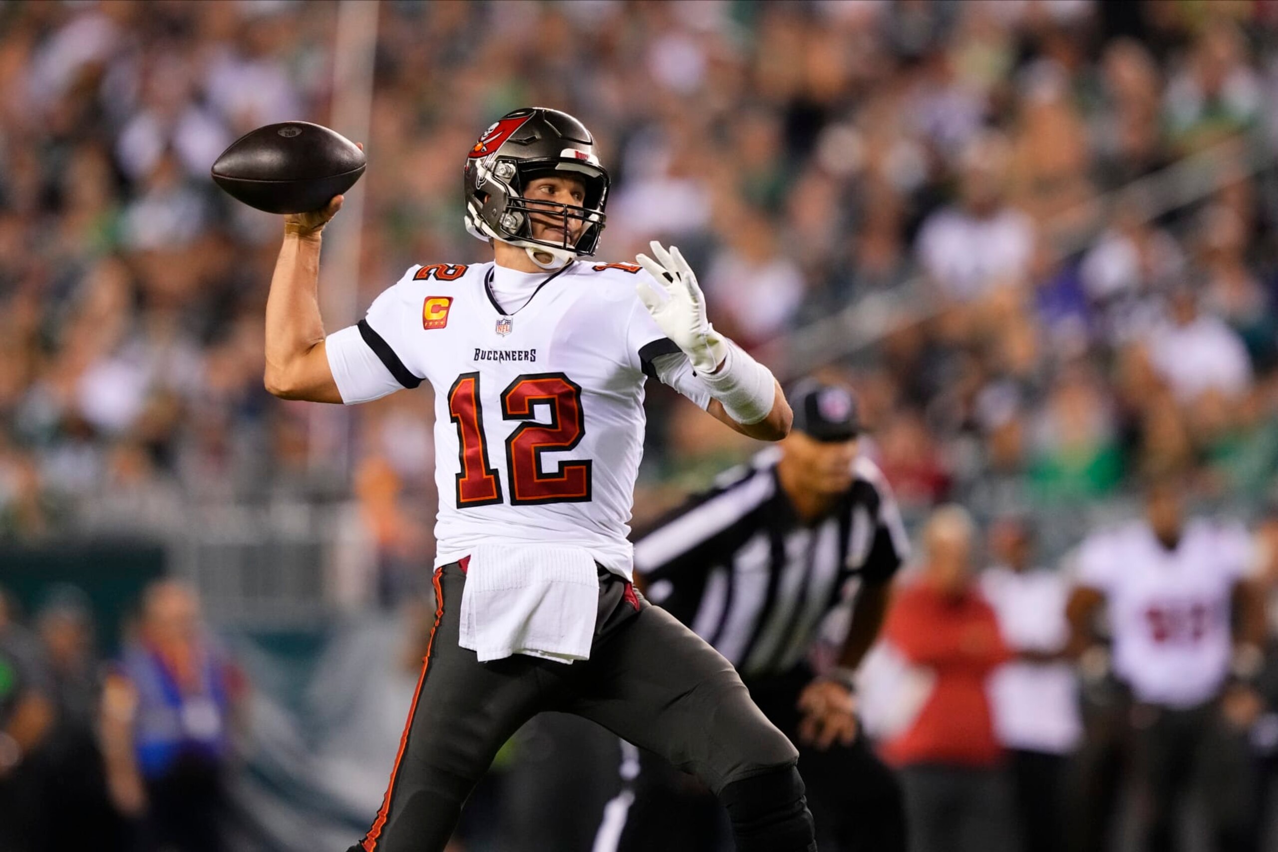 FILE - Tampa Bay Buccaneers' Tom Brady plays during an NFL football game in Philadelphia, Pa., on Thursday, Oct. 14, 2021. Brady cited “unfinished business” as one of the reasons for ending a brief retirement, and the Tampa Bay Buccaneers remain committed to surrounding the seven-time Super Bowl champion with everything he needs to win an eighth ring. (AP Photo/Matt Slocum, File)