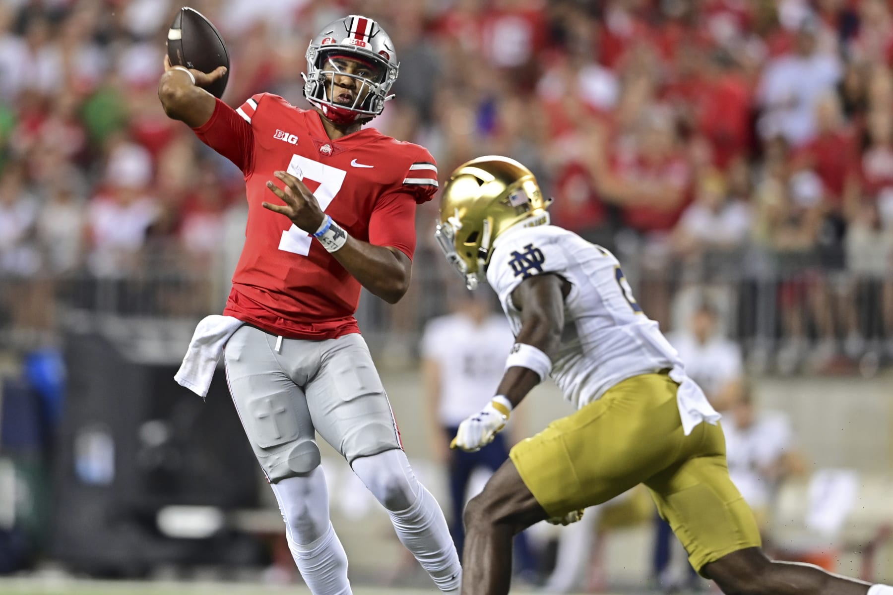 Ohio State quarterback C.J. Stroud throws while being pressured by Notre Dame safety DJ Brown during the second quarter of an NCAA college football game Saturday, Sept. 3, 2022, in Columbus, Ohio. (AP Photo/David Dermer)