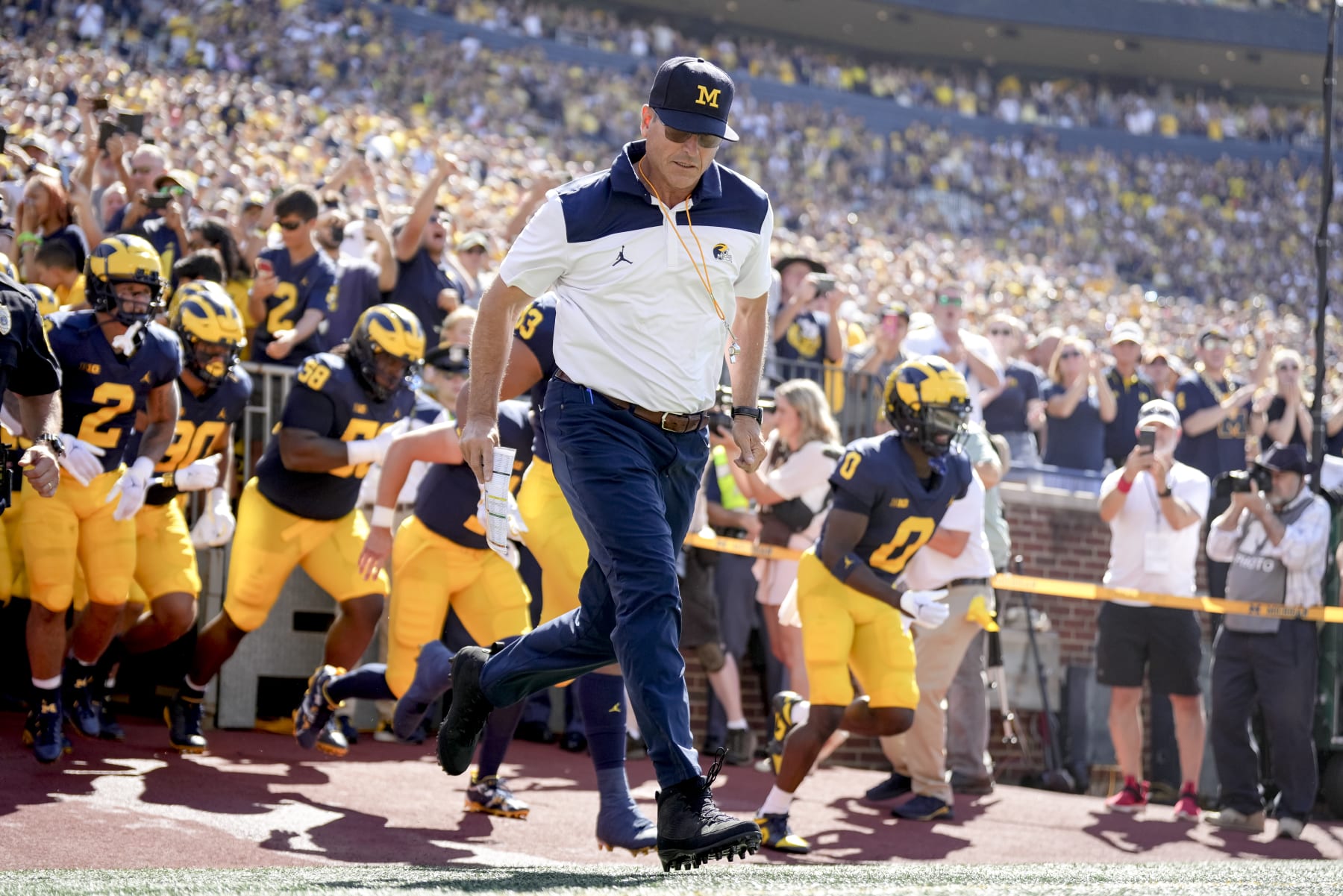 ANN ARBOR, MICHIGAN - SEPTEMBER 03: Head coach Jim Harbaugh of the Michigan Wolverines takes the field with his players before the first half against the Colorado State Rams at Michigan Stadium on September 03, 2022 in Ann Arbor, Michigan. (Photo by Nic Antaya/Getty Images)